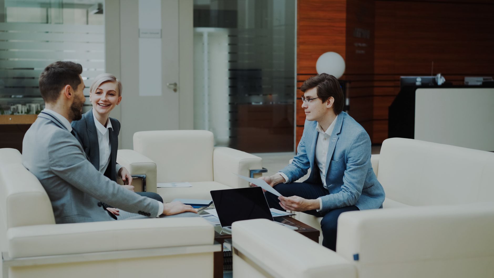 Group of professionals having a productive business meeting in a modern office setting.