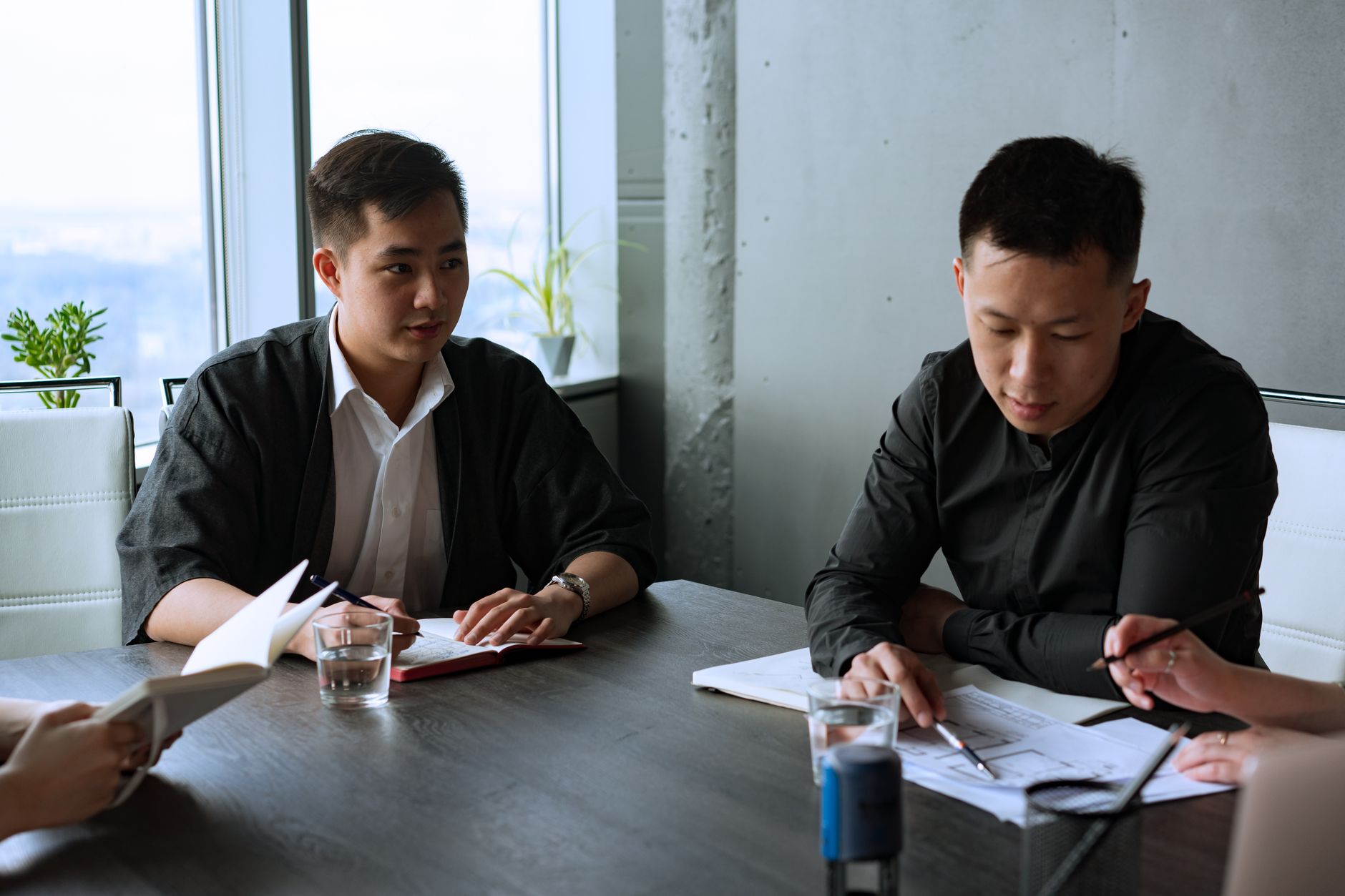 Group of professionals discussing business strategies in a modern office setting.