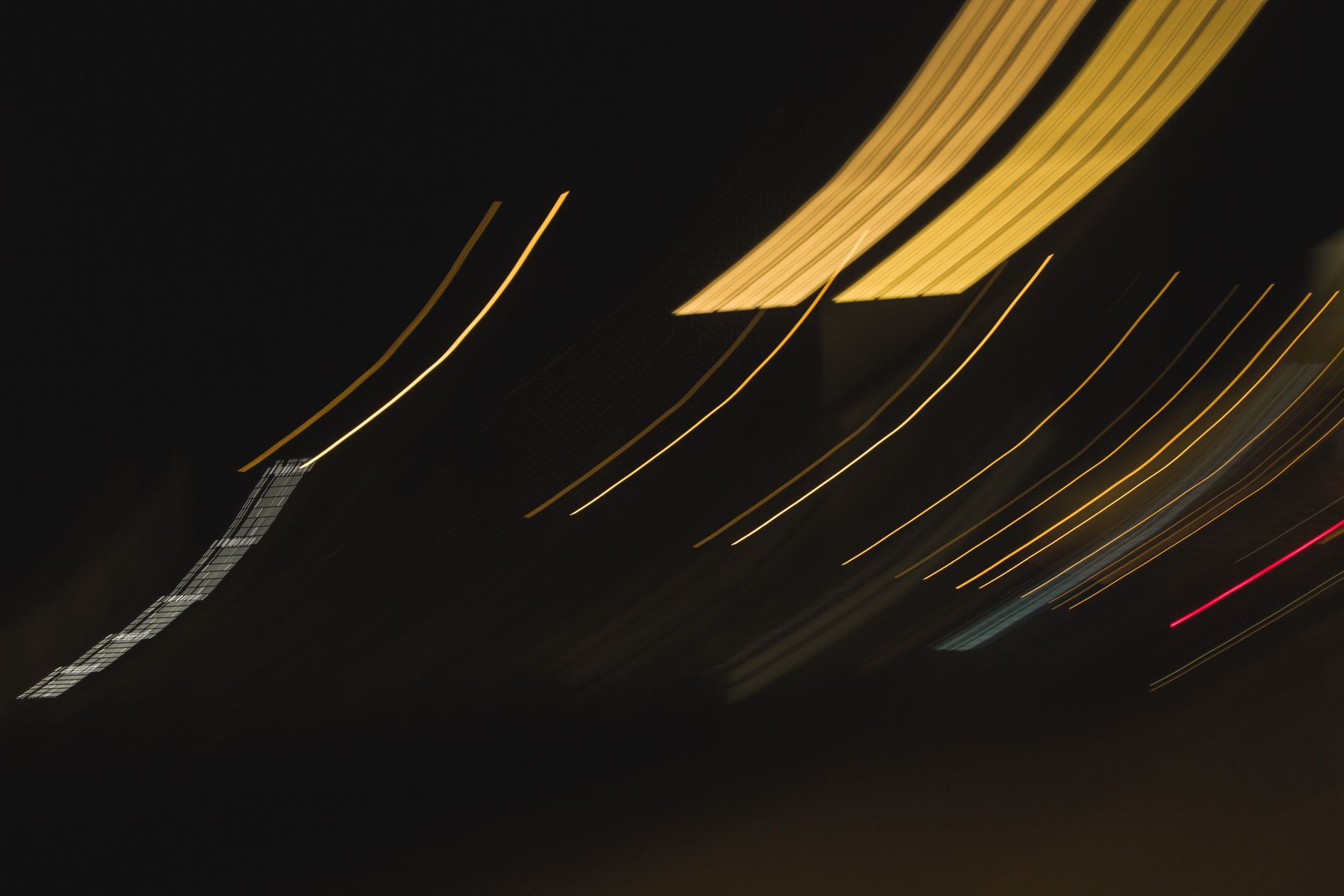 Elegant abstract lines in motion against a deep dark background create a captivating night-time visual.