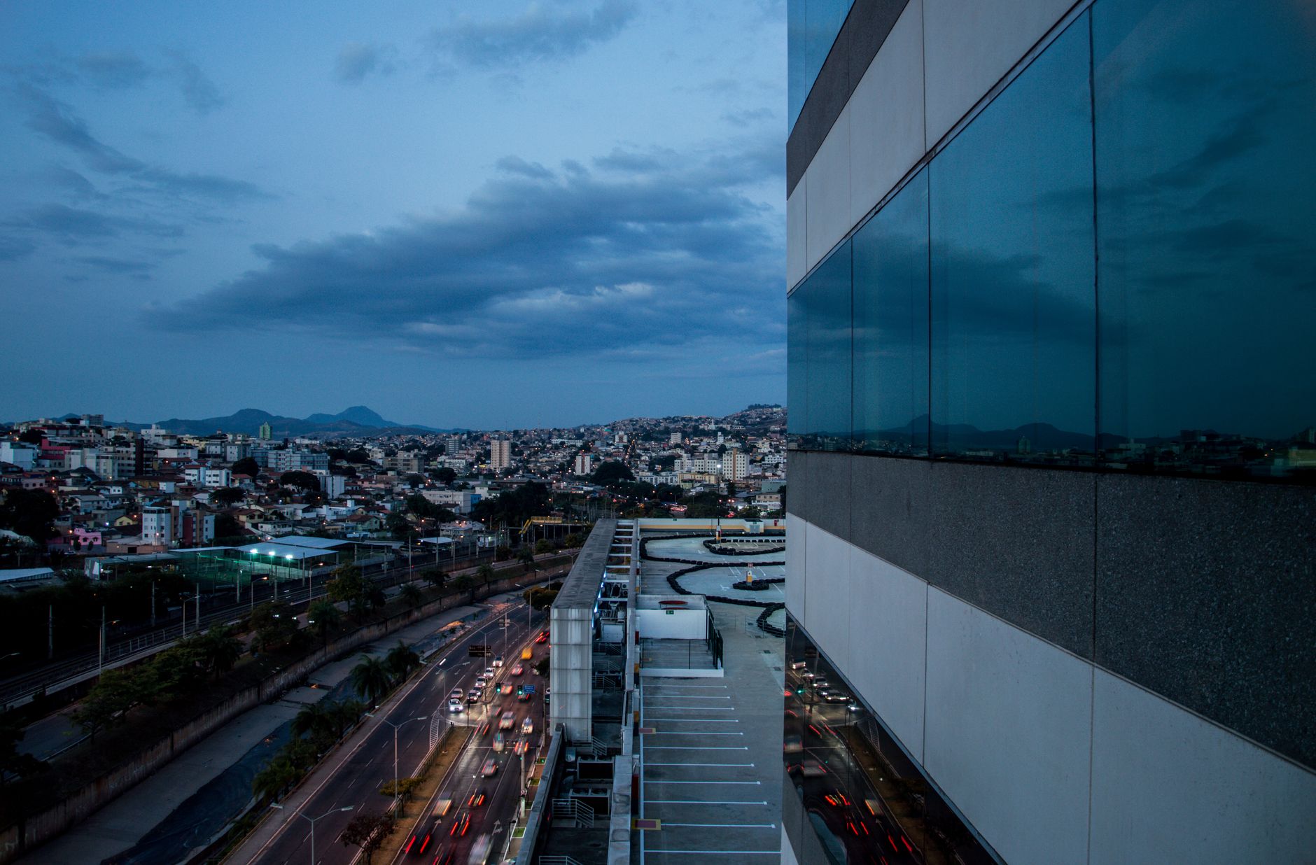 Capture of a modern metropolis with bustling streets and reflections at dusk, capturing urban vibrancy.