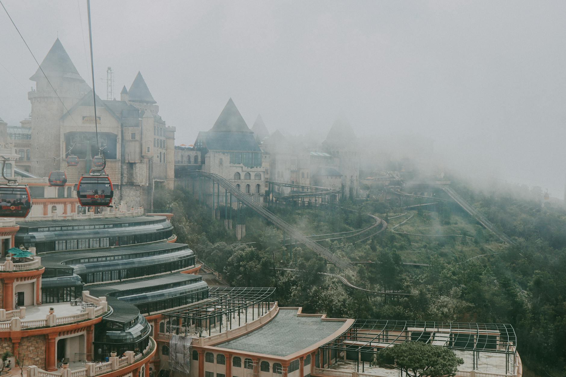 Capture of iconic French village in Ba Na Hills, Vietnam enveloped in mist and viewed from above.