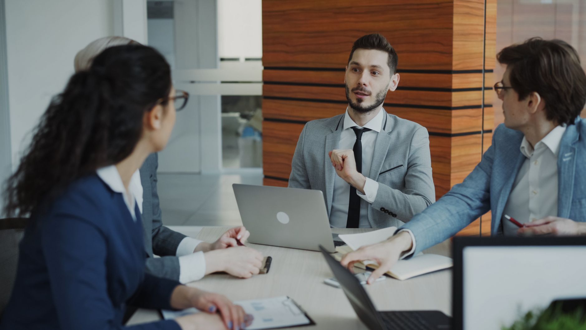 Professional business team collaborating in a modern office meeting.