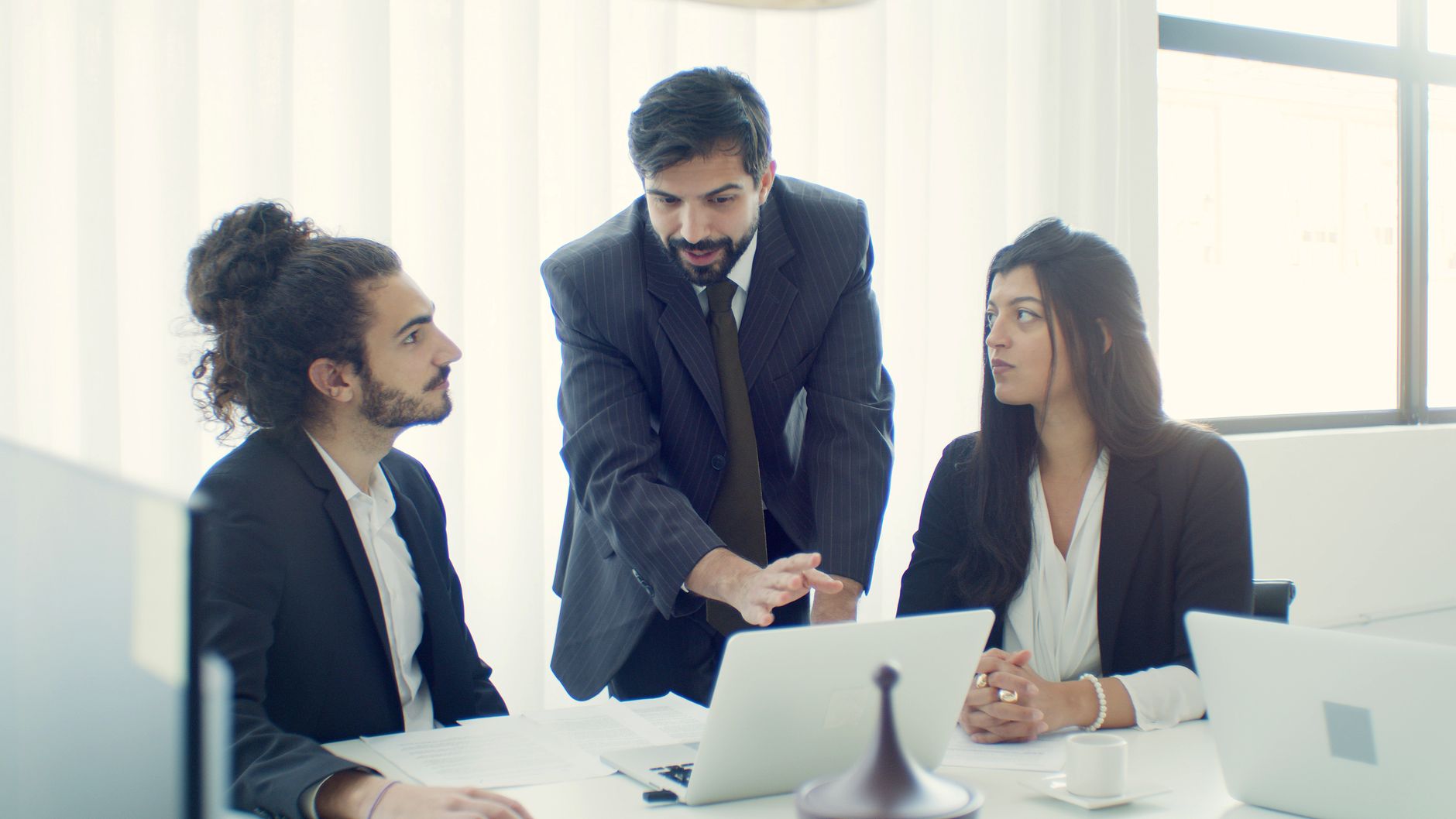 Professional team in office discussing a business project with focused collaboration.