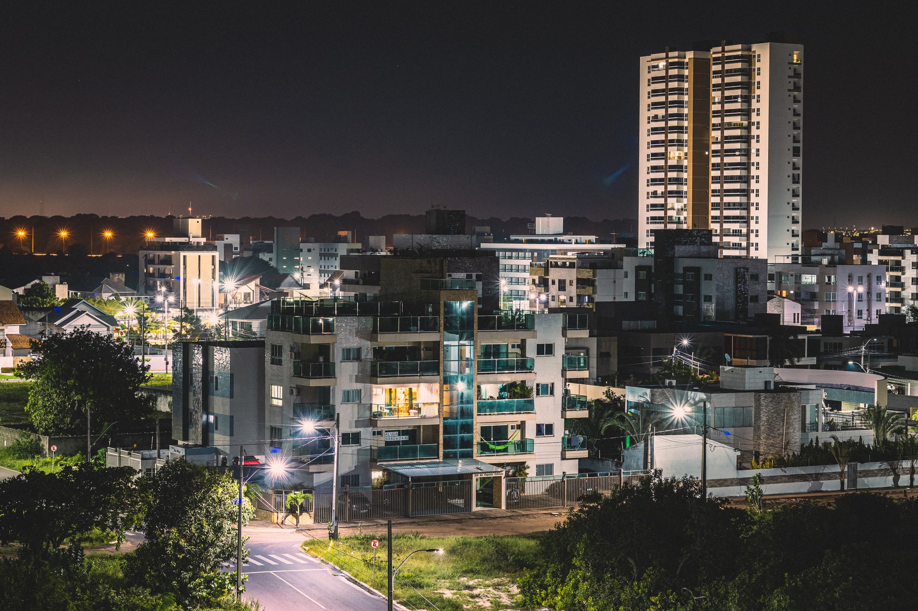 Explore the vibrant urban nightscape of João Pessoa, Brazil, illuminated under city lights.