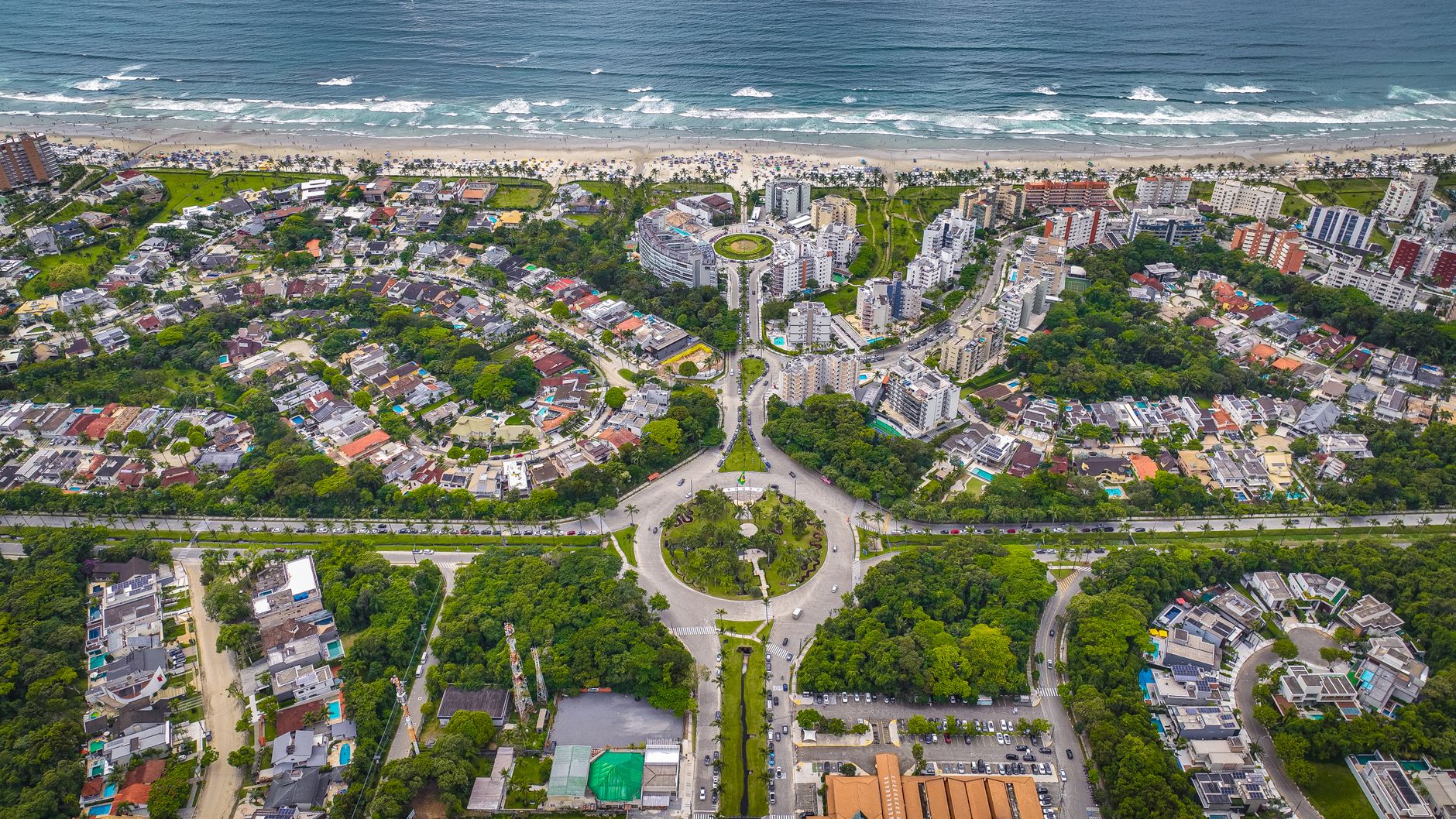 Stunning aerial shot of a coastal city showcasing lush greenery and intricate architecture.