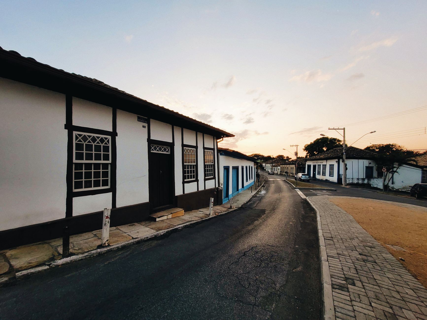 Explore a picturesque colonial street in Brazil during sunset, showcasing traditional architecture and a serene atmosphere.