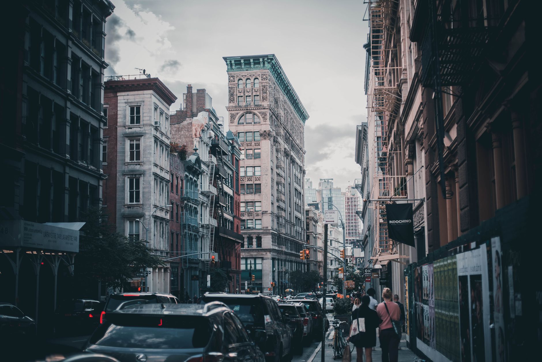 Urban scene capturing traffic and pedestrians in historic Soho, NYC.