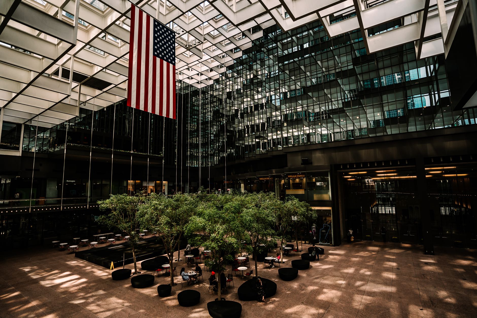 Spacious modern atrium in Minneapolis with American flag, architecture and natural light.