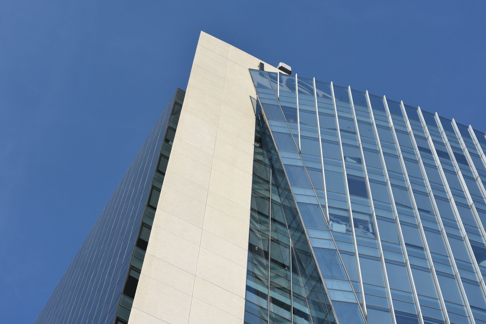 A striking low-angle view of a contemporary skyscraper in Mexico City with a steel and glass facade.