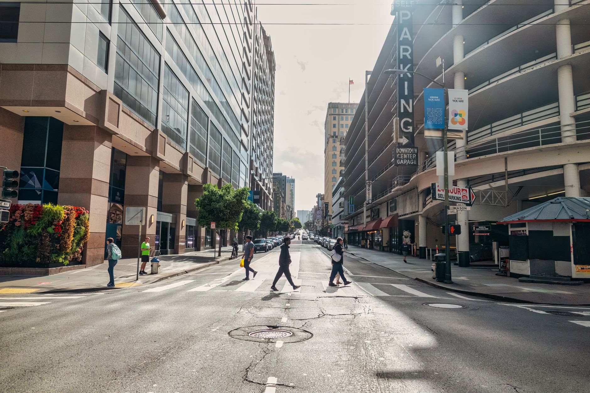 Street scene in San Francisco showcasing urban architecture and diverse pedestrians crossing.