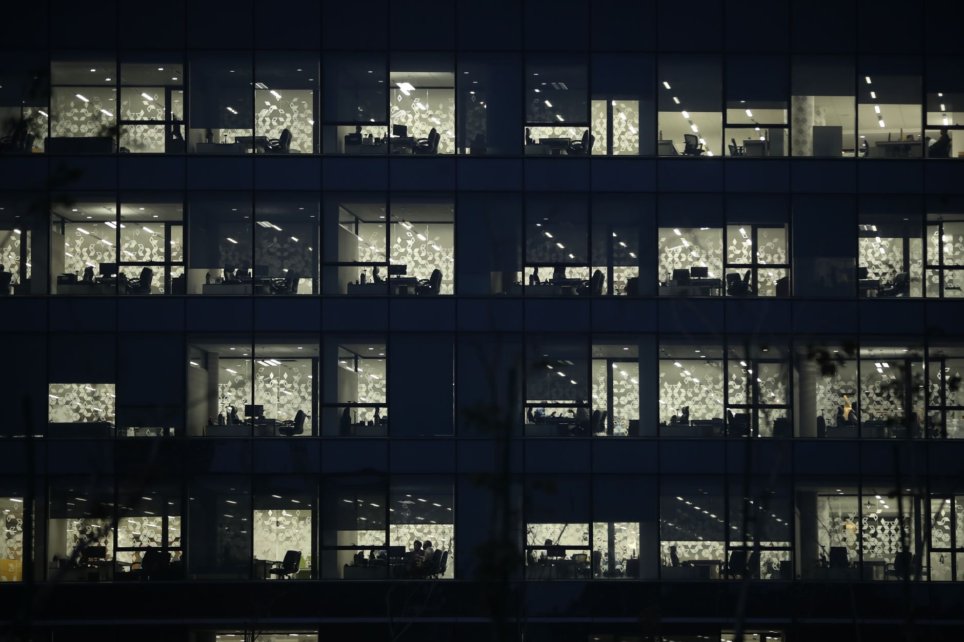 View of an office building at night with illuminated windows in Gandhinagar, India.