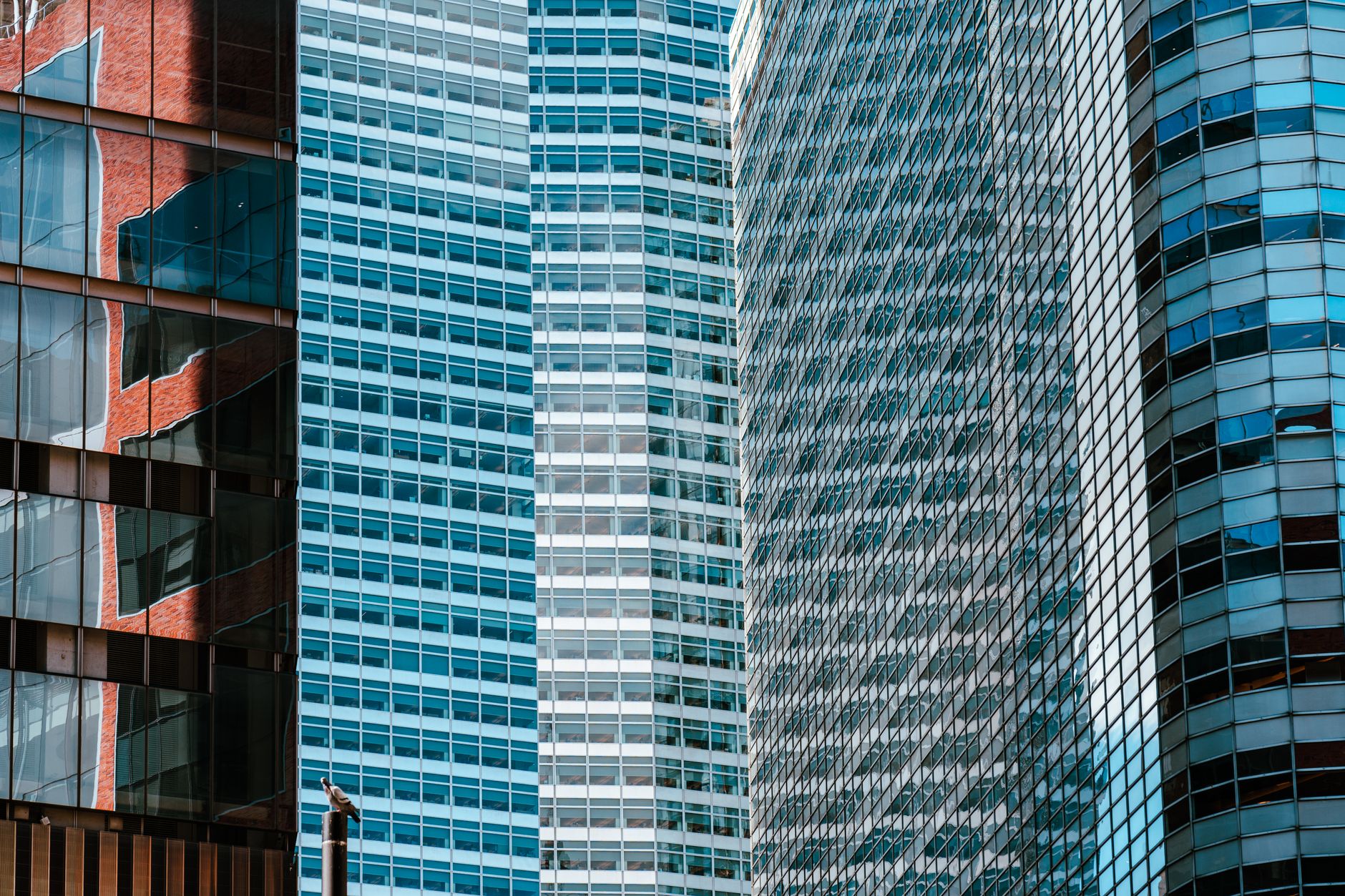 Close-up view of contemporary skyscrapers with reflections on glass facades in urban financial district.