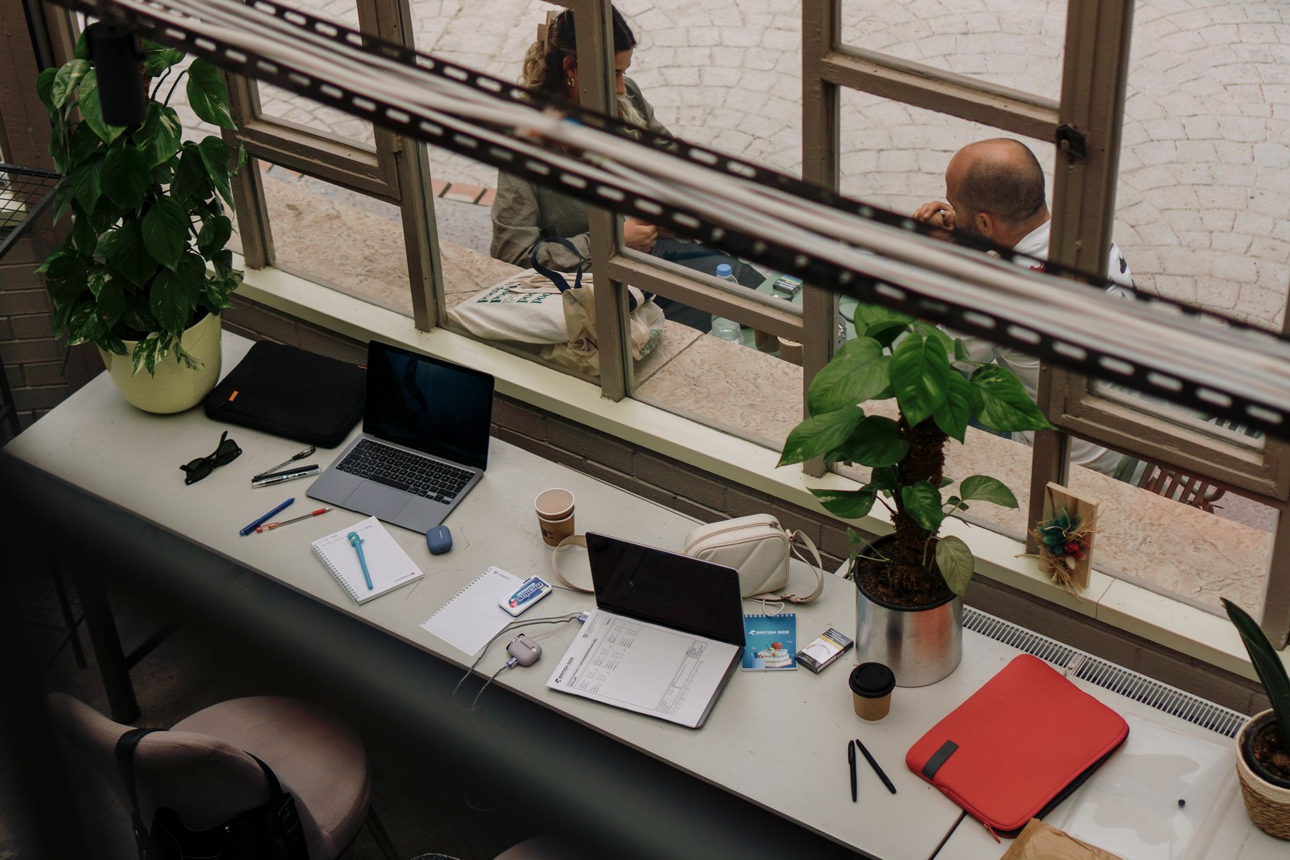 Cozy indoor workspace with laptop and plants, perfect for remote work inspiration.