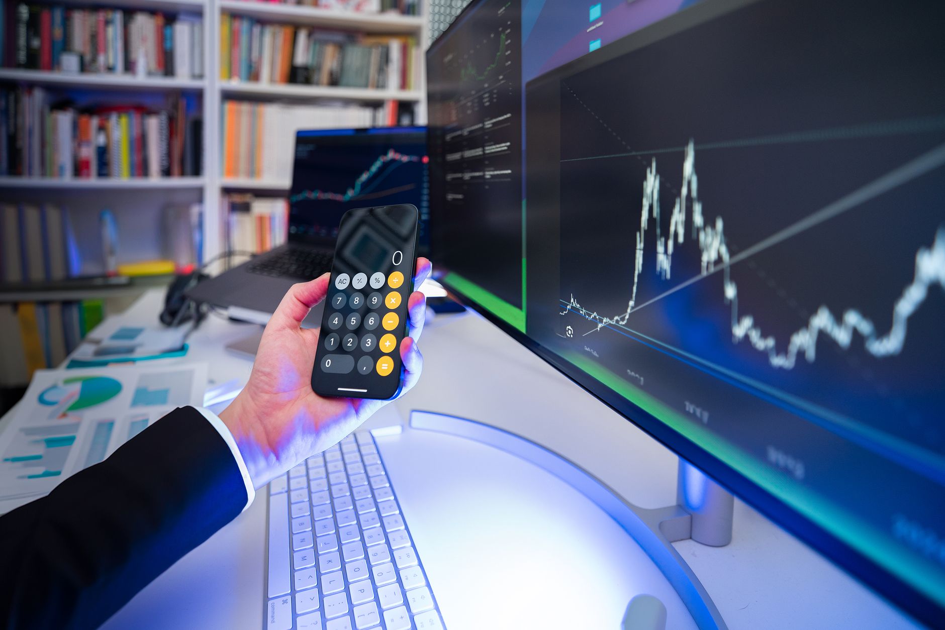 A modern office desk setup with financial analysis tools, highlighting technology in business strategy.