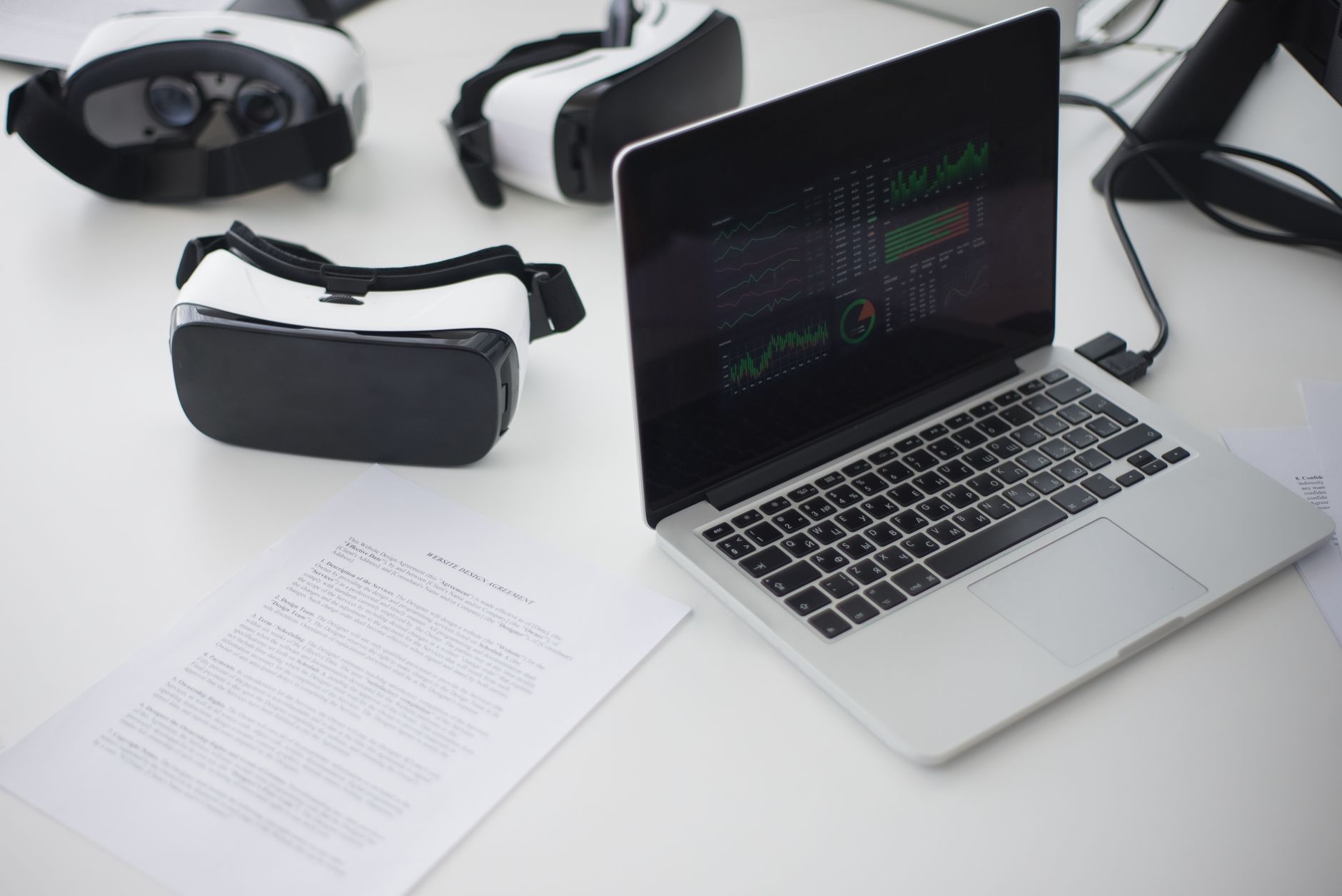 Modern workspace featuring laptop and VR headsets, ideal for tech themes.