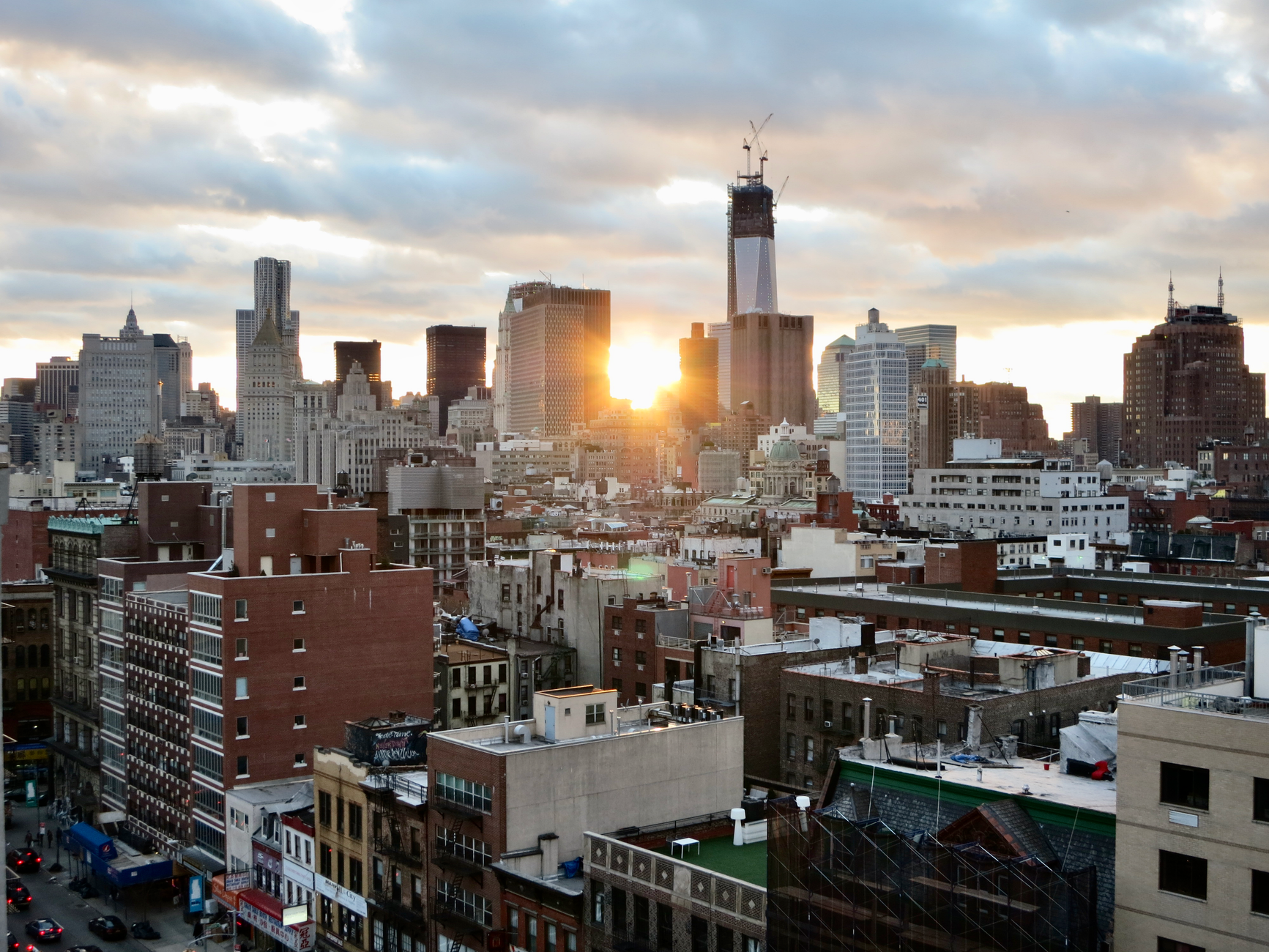 Stunning sunset illuminating New York City skyline with urban architecture and skyscrapers.