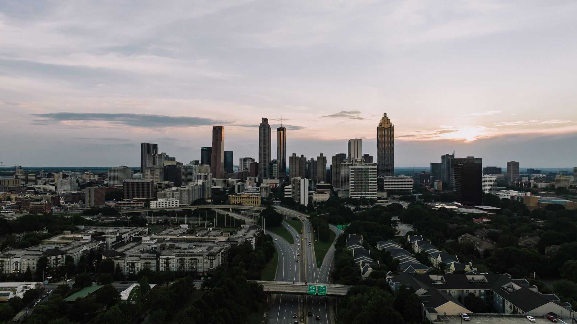 Captivating aerial view of the Atlanta skyline at dusk, showcasing the city's iconic skyscrapers and bustling highways.