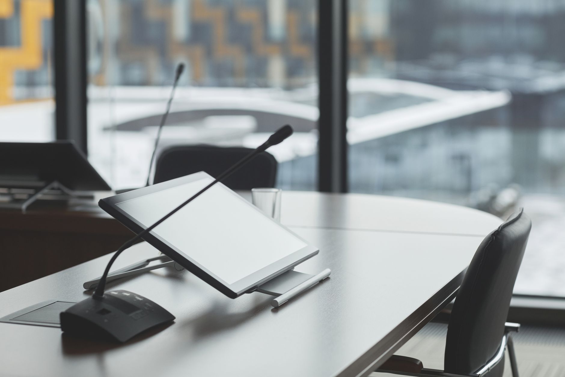 High-tech conference room with digital tablets and microphones for effective communication.