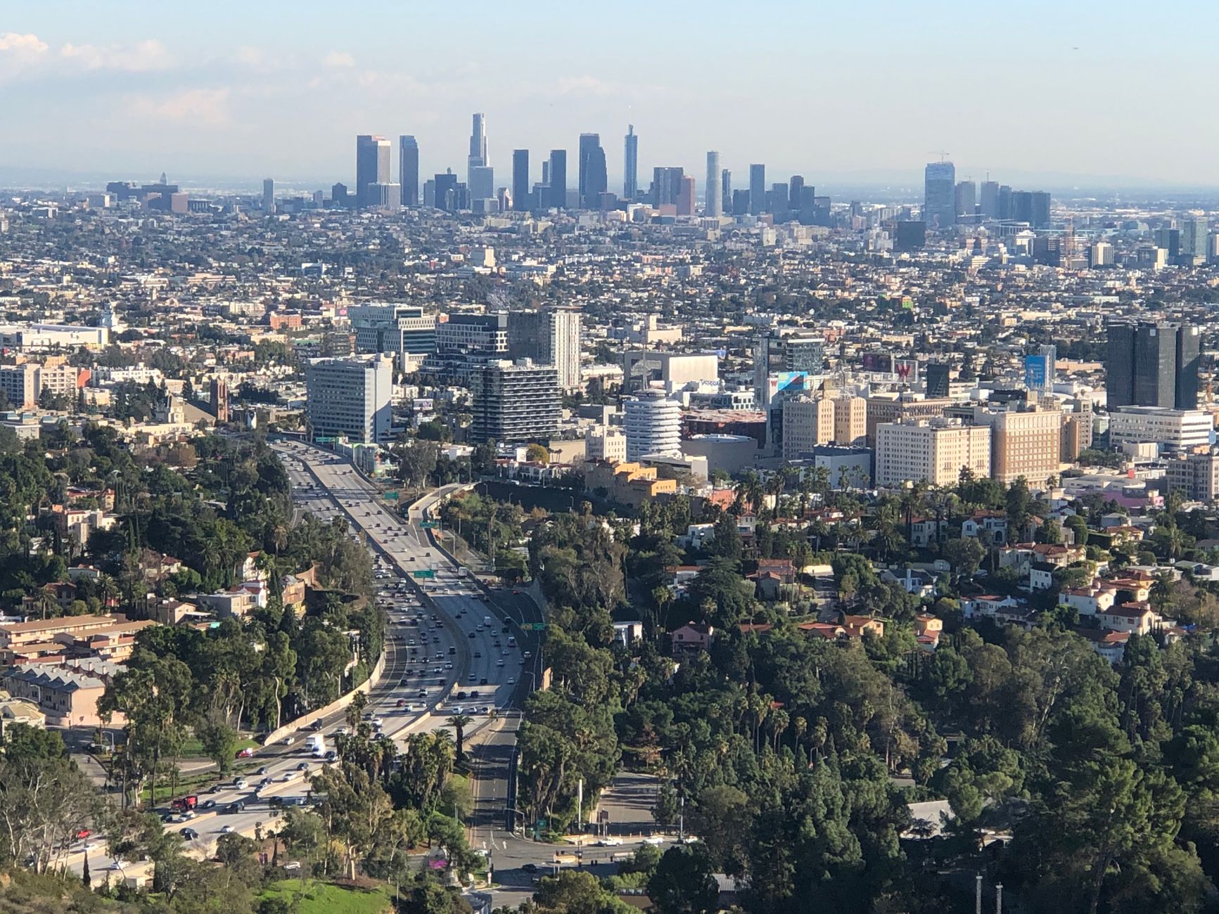 A stunning aerial view of Los Angeles skyline with urban cityscape and freeway.