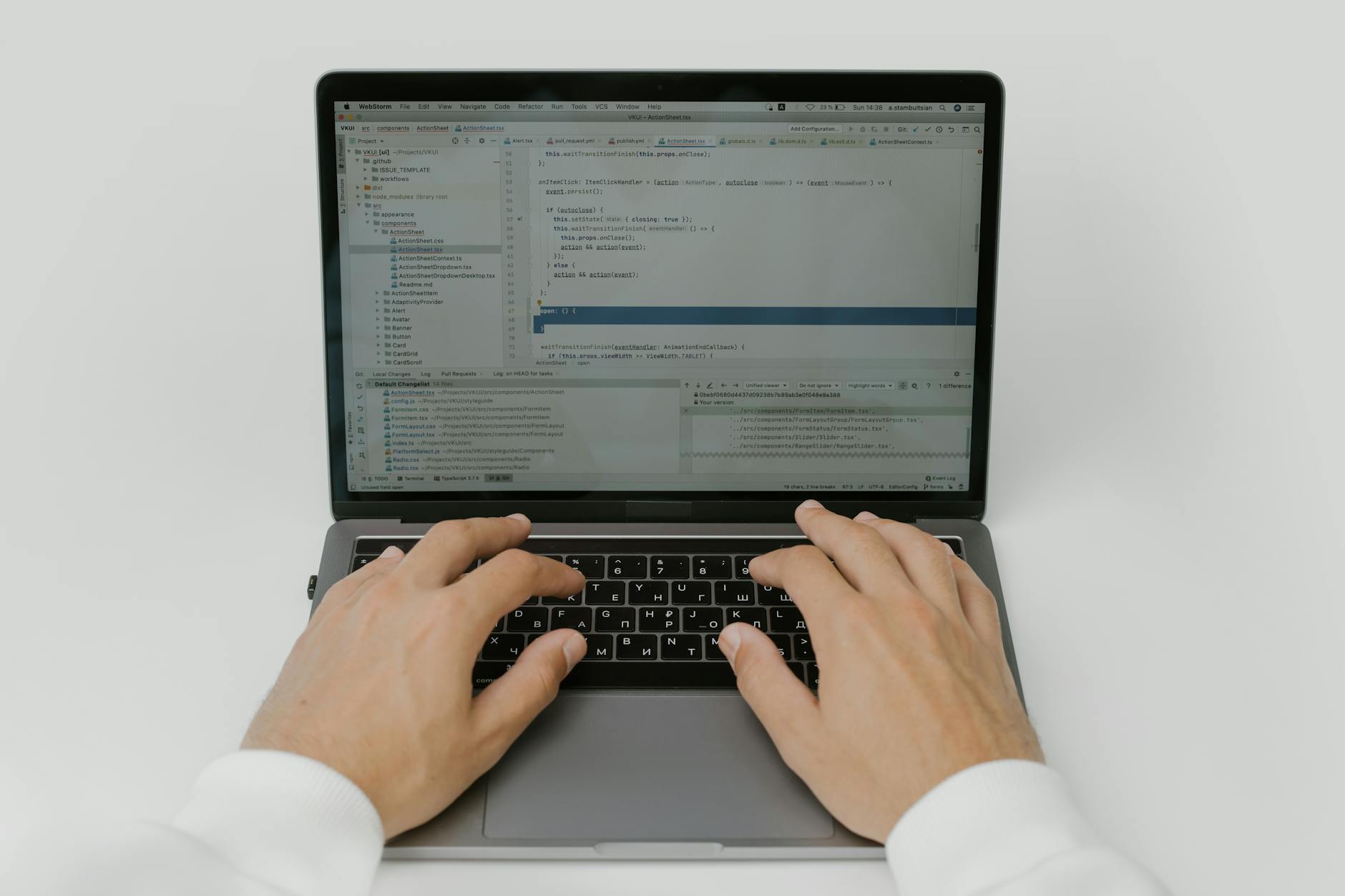 Close-up of hands coding on a laptop, showcasing software development in action.