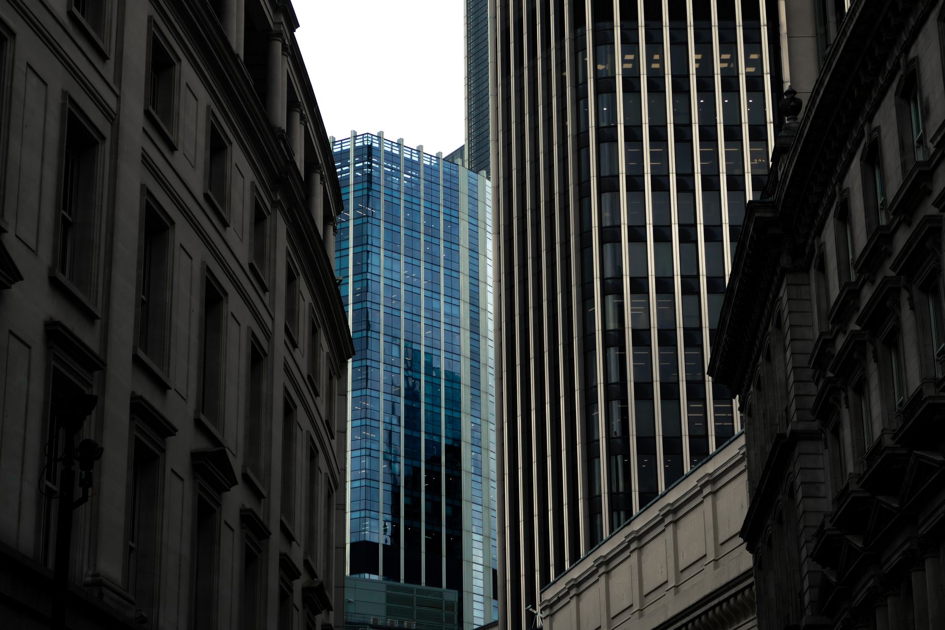 A view of modern skyscrapers with glass facades in an urban downtown area.
