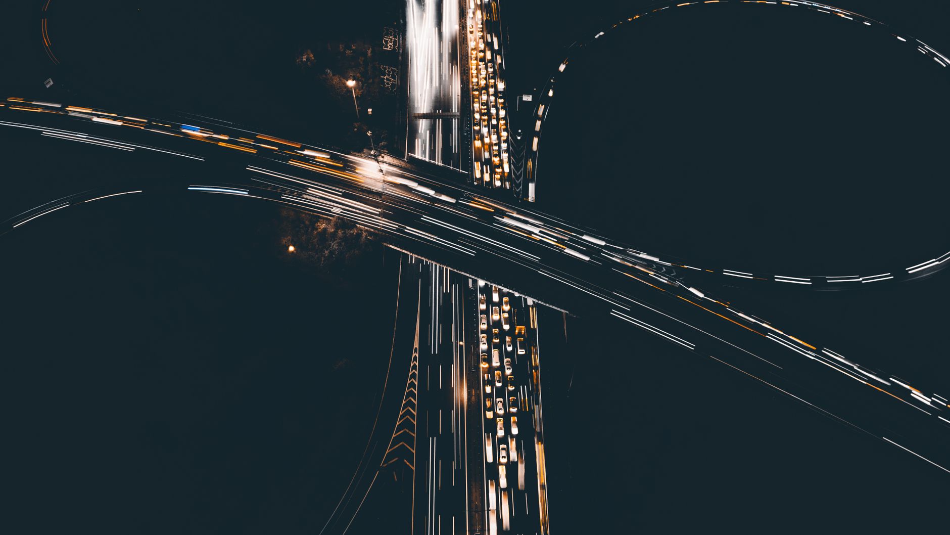 Captivating aerial shot of a busy highway interchange with light trails at night.