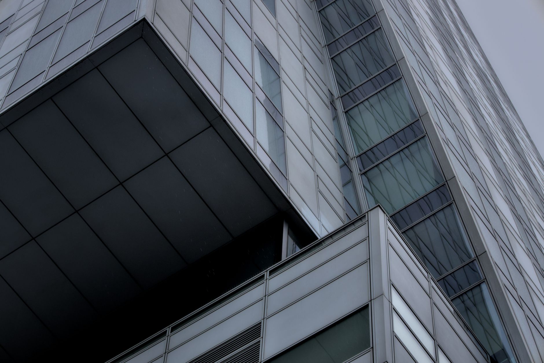 Close-up of a glass facade on a modern skyscraper in Warsaw, showcasing urban architecture.