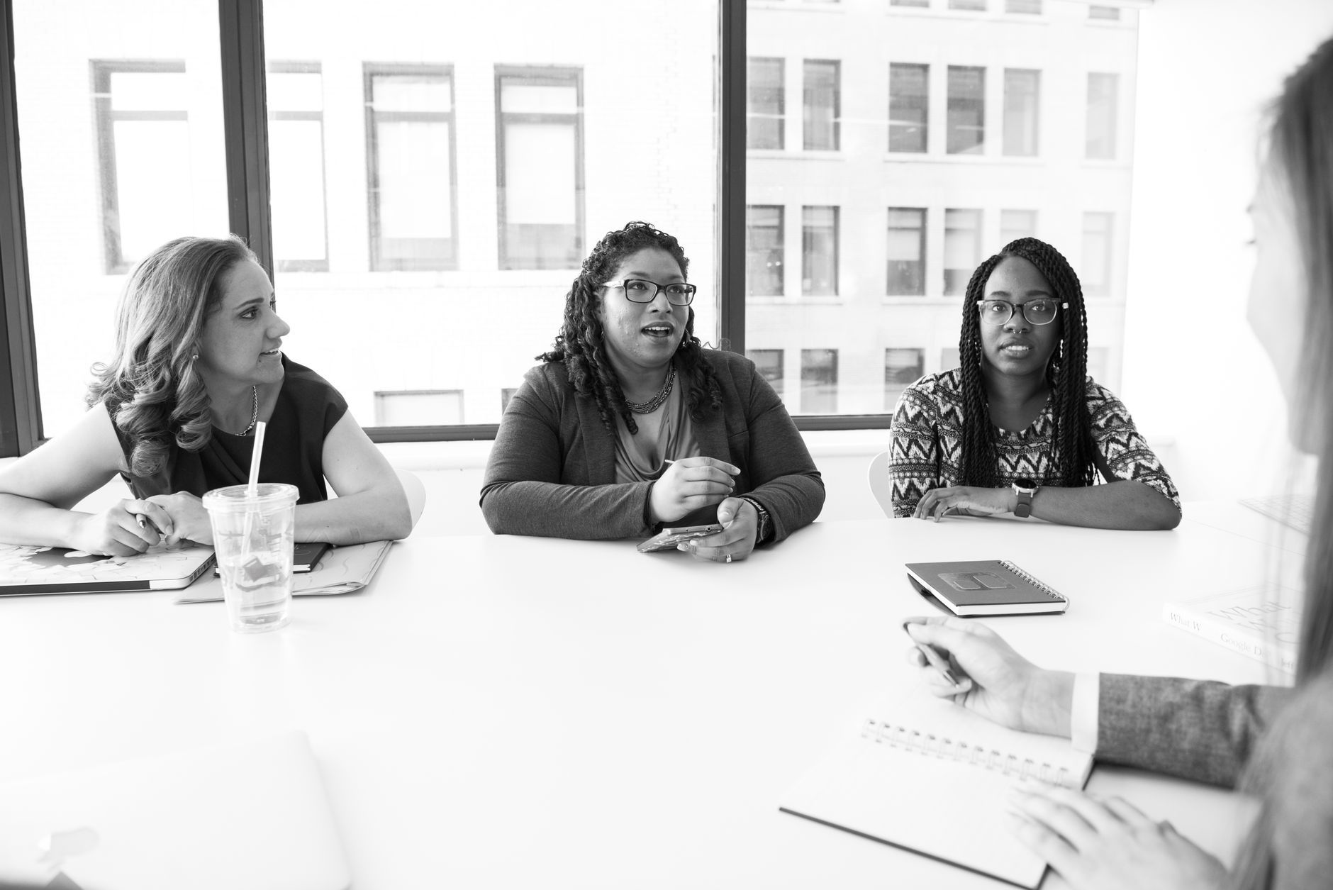 Professional women meeting in a modern office setting, focusing on collaboration and teamwork.