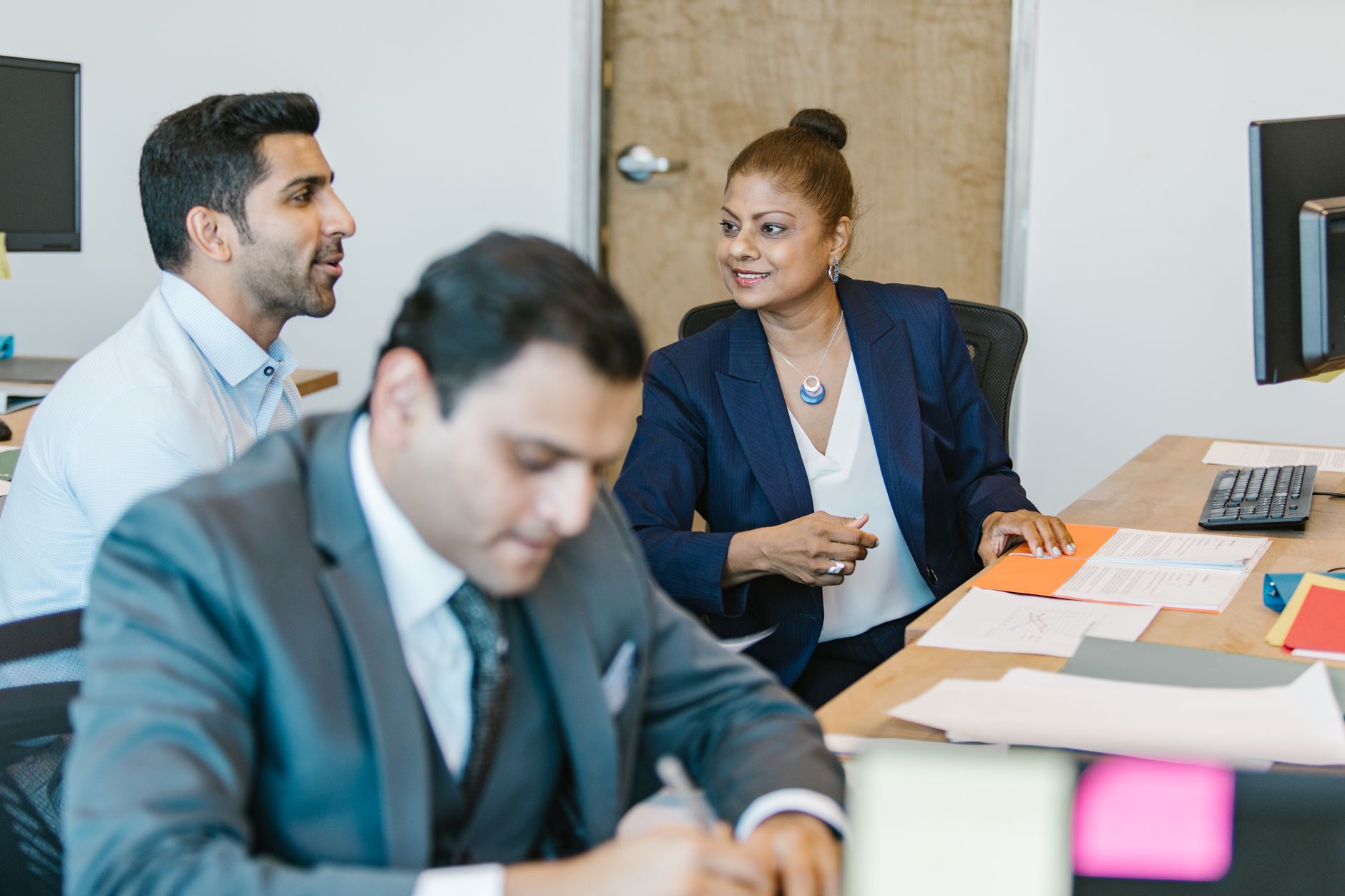 Professional team discussing project ideas in an office setting, featuring diverse employees.