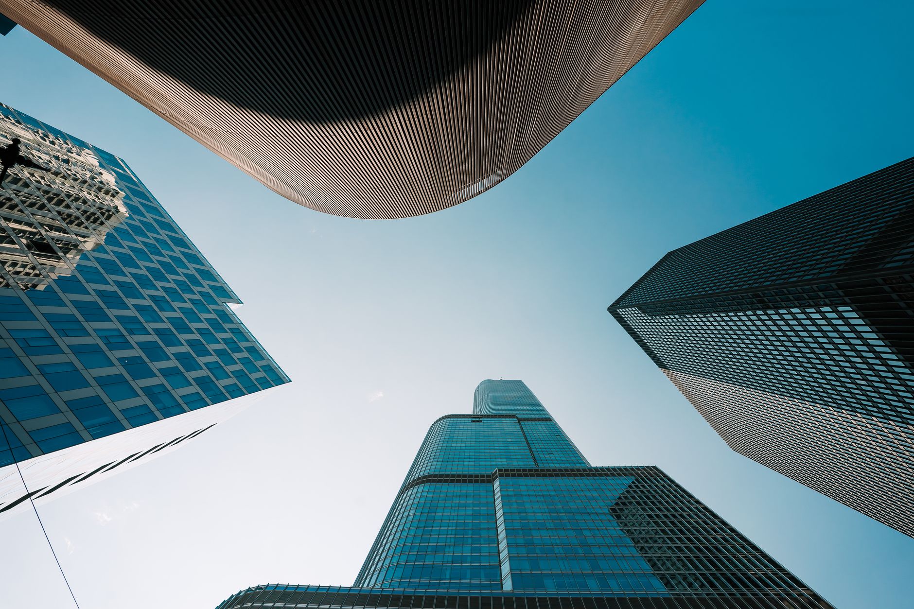 Low angle view of modern skyscrapers against a clear blue sky in downtown Chicago.