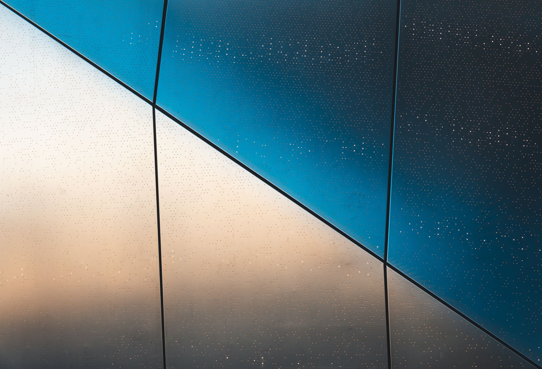 Abstract blue and beige geometric facade with dotted pattern; modern architecture in New York.
