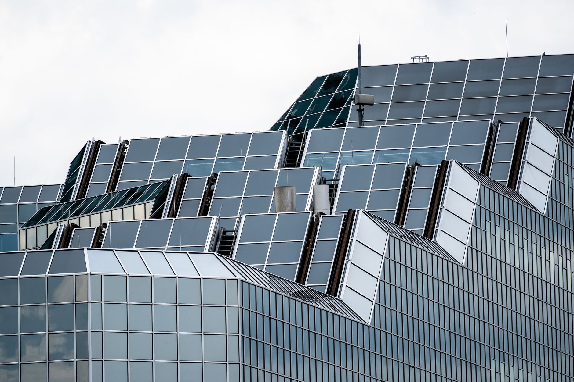 Close-up of a contemporary glass and steel skyscraper facade in an urban setting.