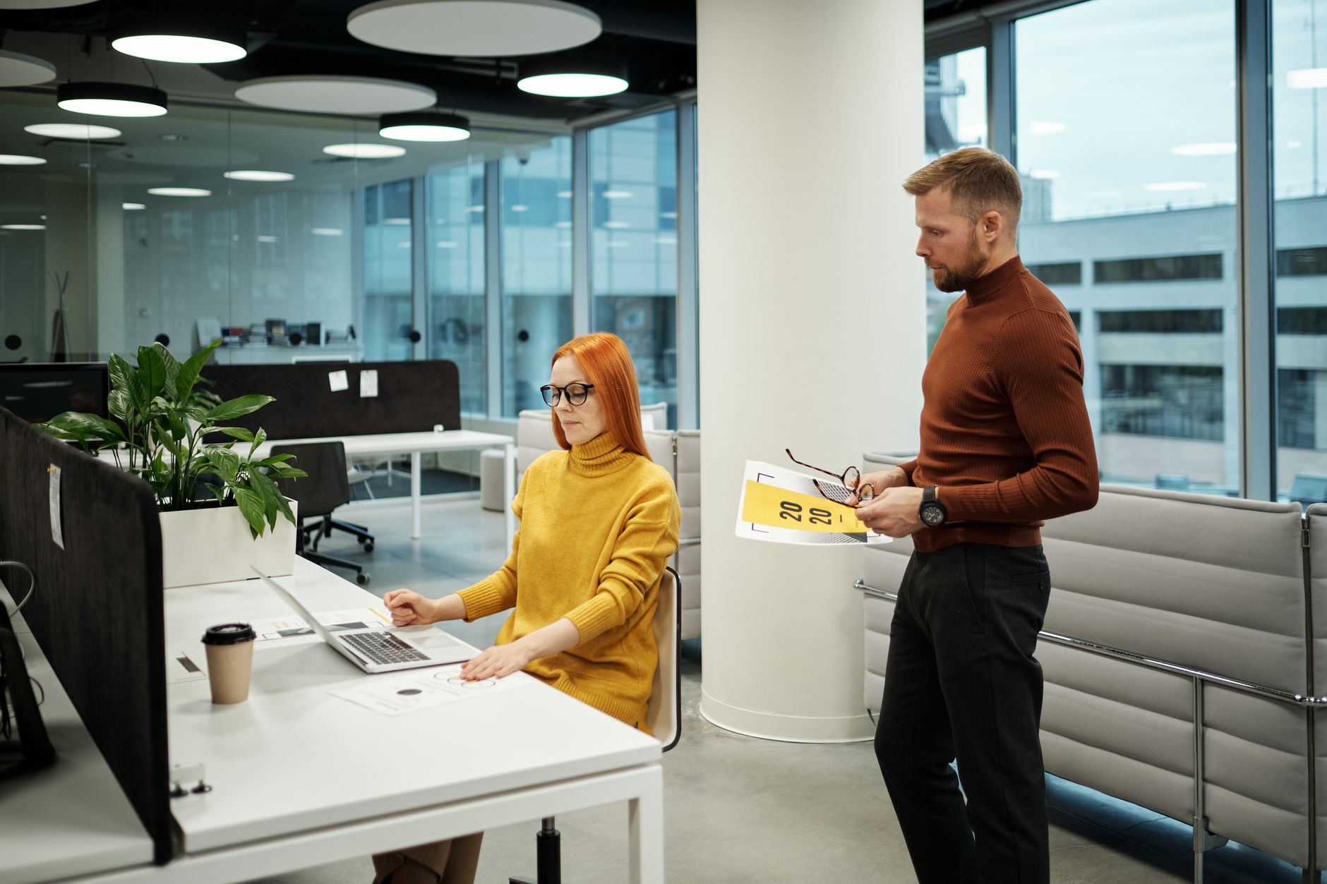 Colleagues collaborating in a modern office, working together on a project.