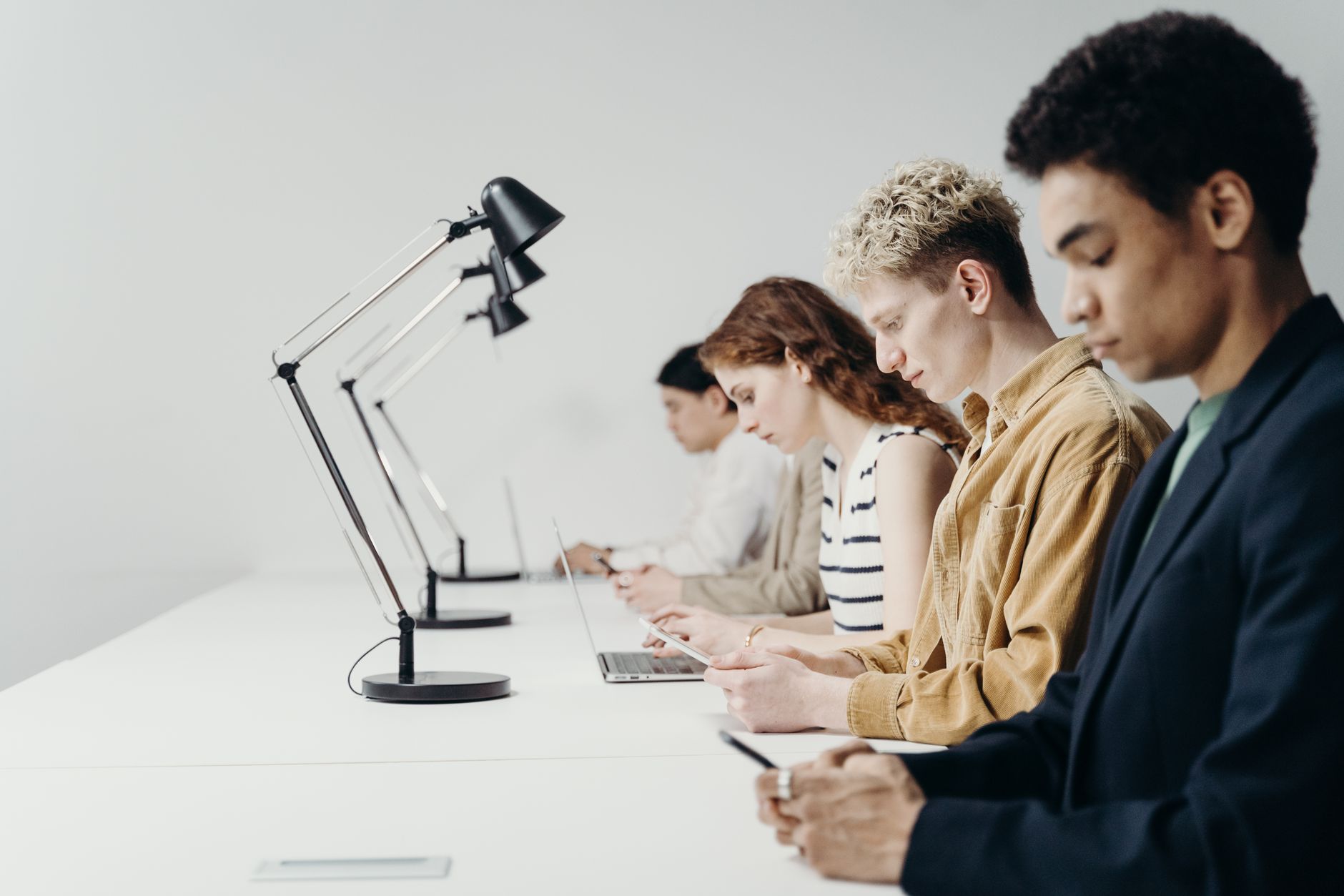 A diverse team working diligently in a modern office setting, showcasing teamwork and technology.