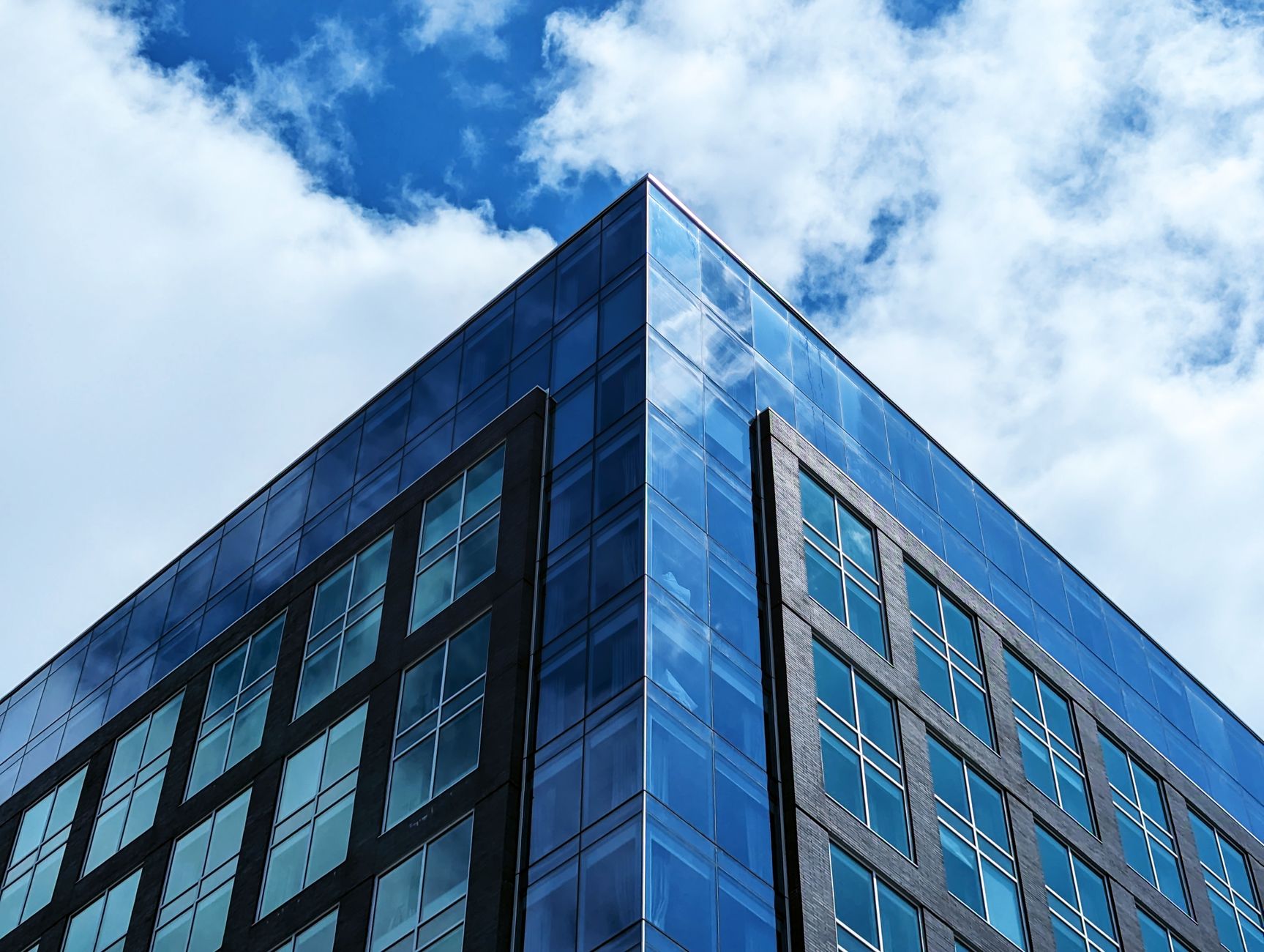 A sleek, modern office building in Halifax, NS, captured against a vibrant blue sky.