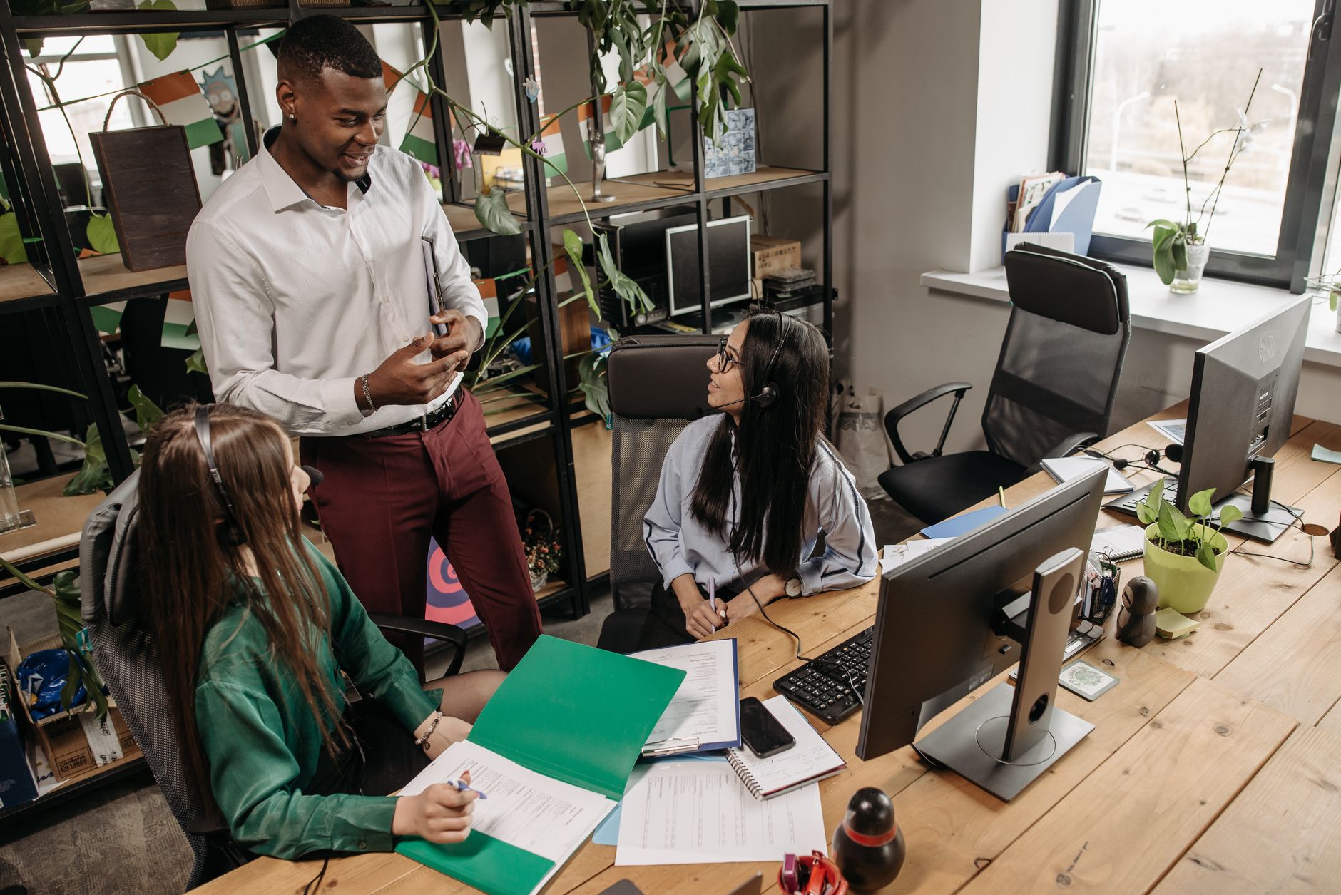A team of diverse workers collaborating in a modern office setting.
