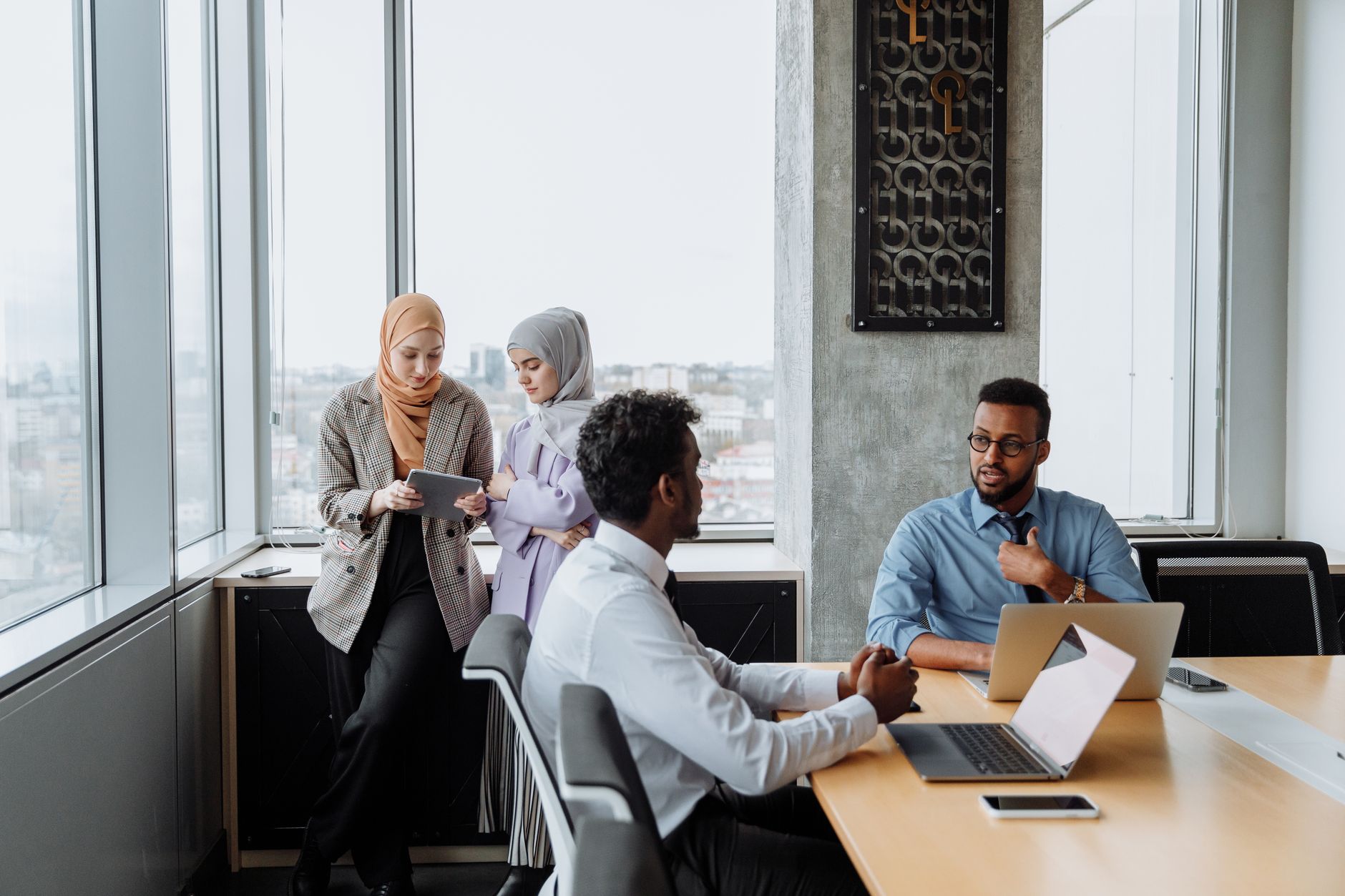 A diverse group of professionals engaged in a collaborative meeting in a modern office space.