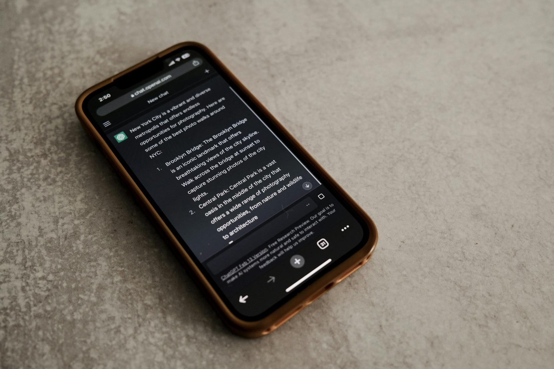 Hand holding a smartphone with AI chatbot app, emphasizing artificial intelligence and technology.