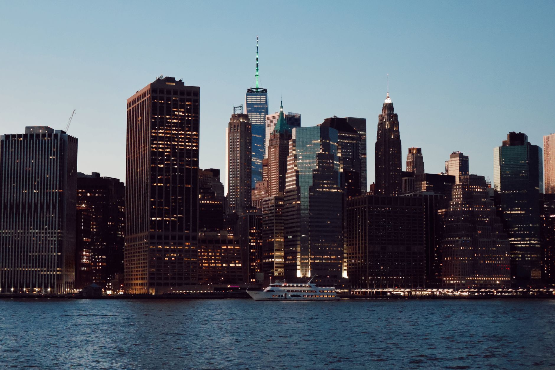 Beautiful view of New York City skyline featuring iconic skyscrapers at sunset.