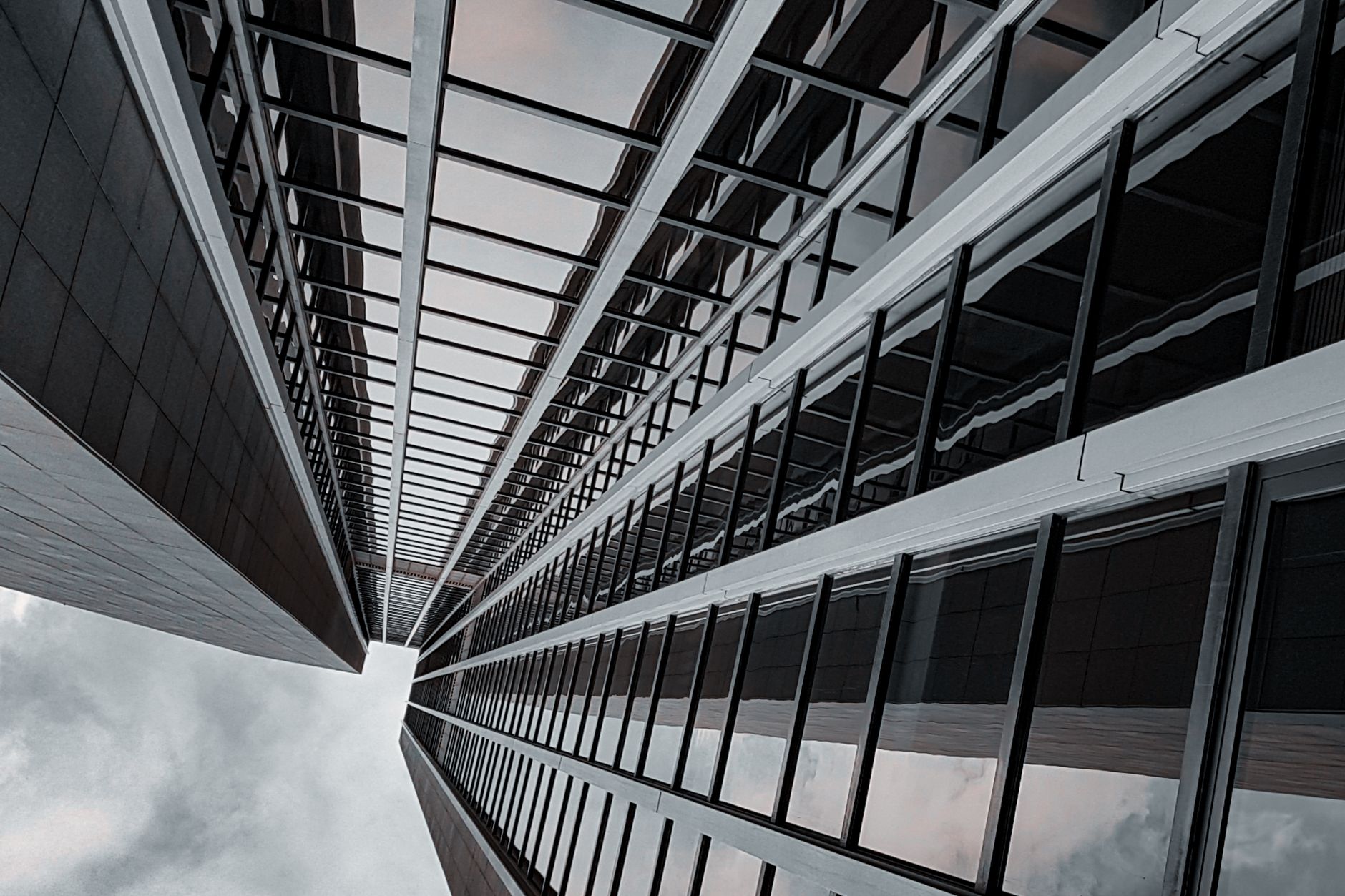 Dramatic perspective of a modern skyscraper in Frankfurt, Germany showcasing geometric design.