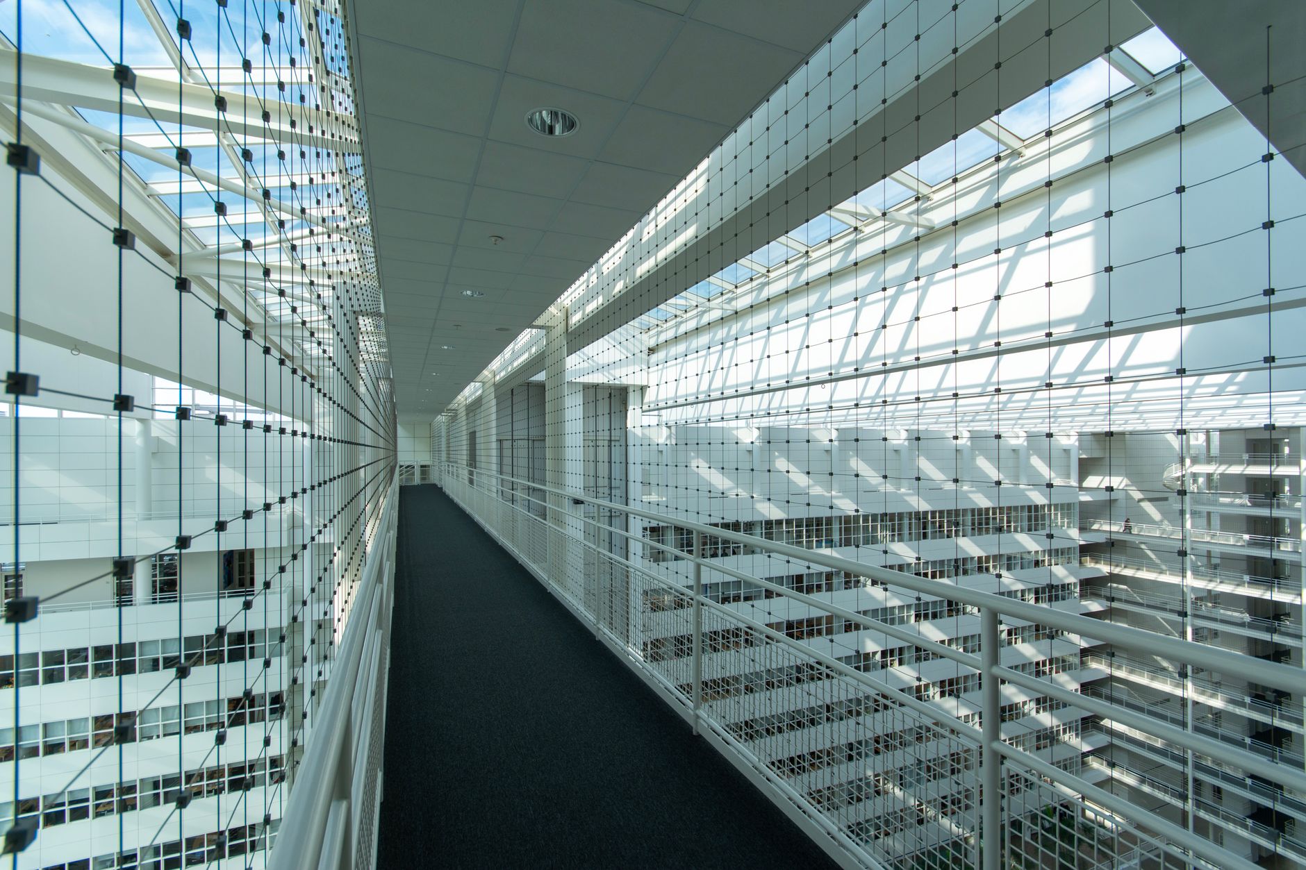 Explore the sleek and abstract interior of a contemporary office building in The Hague, filled with light and geometry.