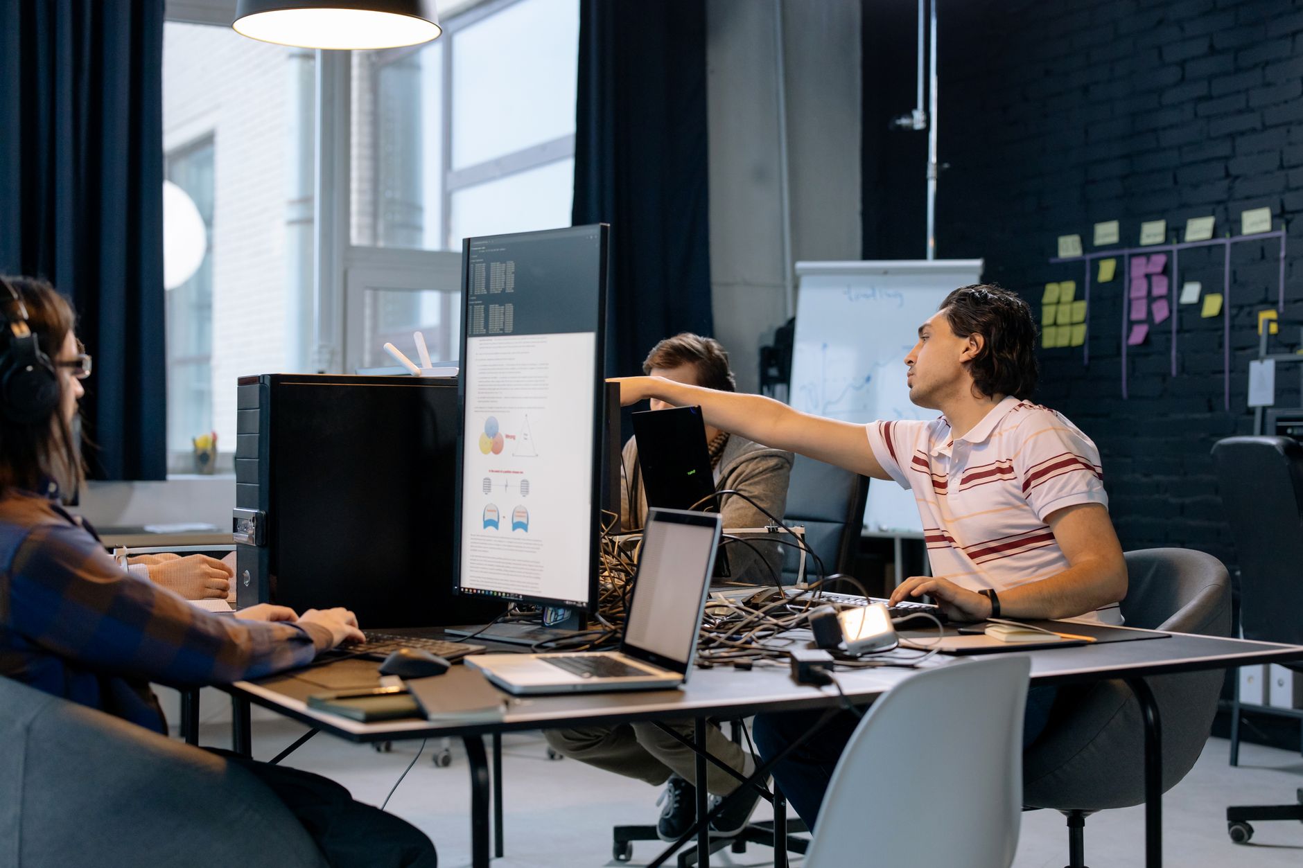 Group of young professionals working on software development in a creative indoor workspace.