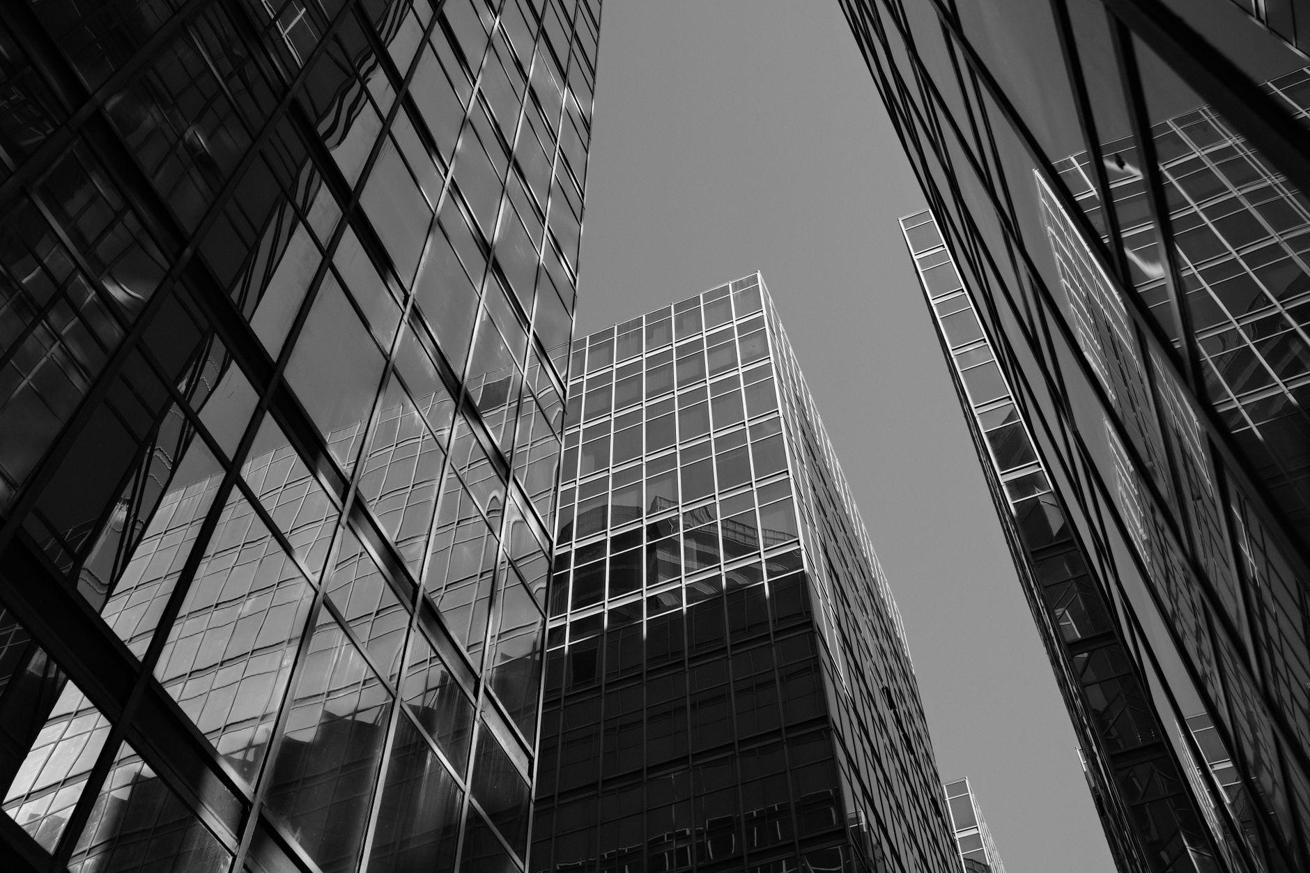 Black and white perspective of modern skyscrapers in Hong Kong showcasing urban architecture.