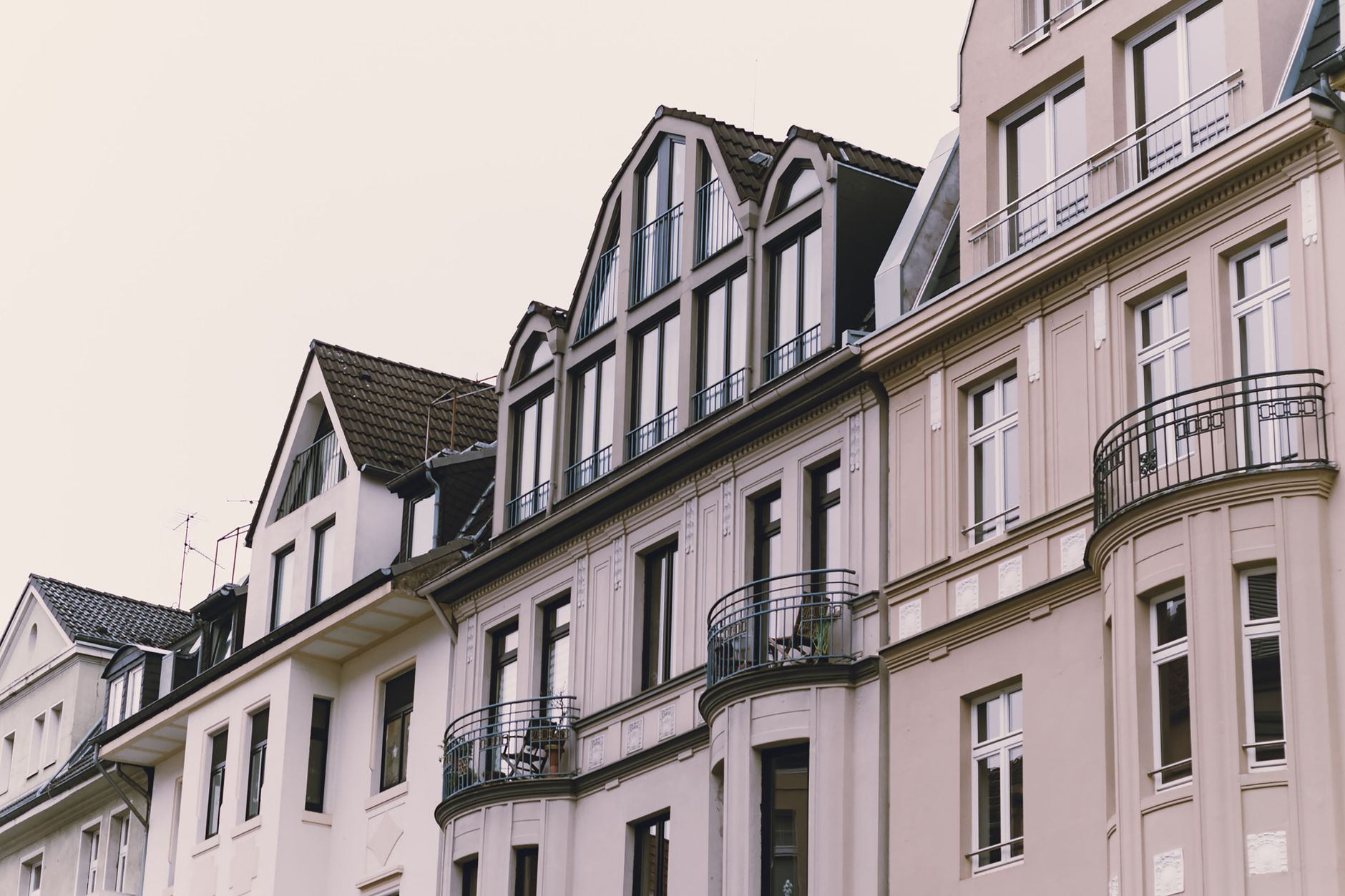 Elegant European townhouse facades with decorative balconies and classic architecture.