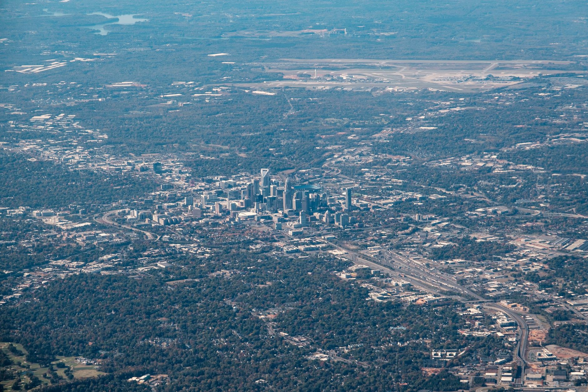 Aerial photograph showcasing the bustling skyline of Charlotte, North Carolina amidst green landscapes.