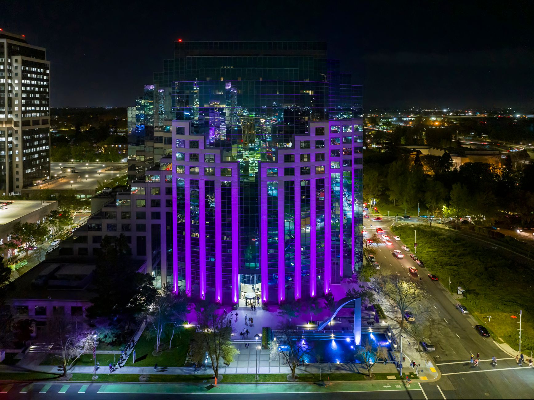 Illuminated skyscraper in downtown Sacramento, California, showcasing colorful lighting at night.