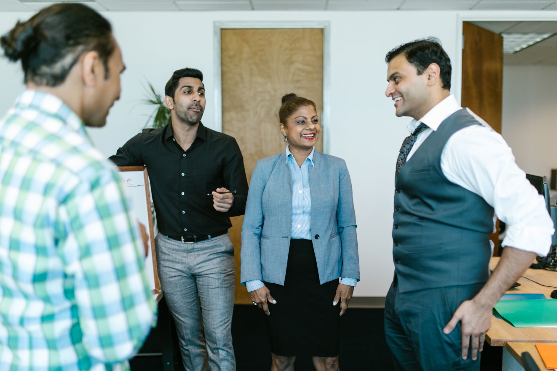 A diverse business team having a lively discussion in a modern office environment.