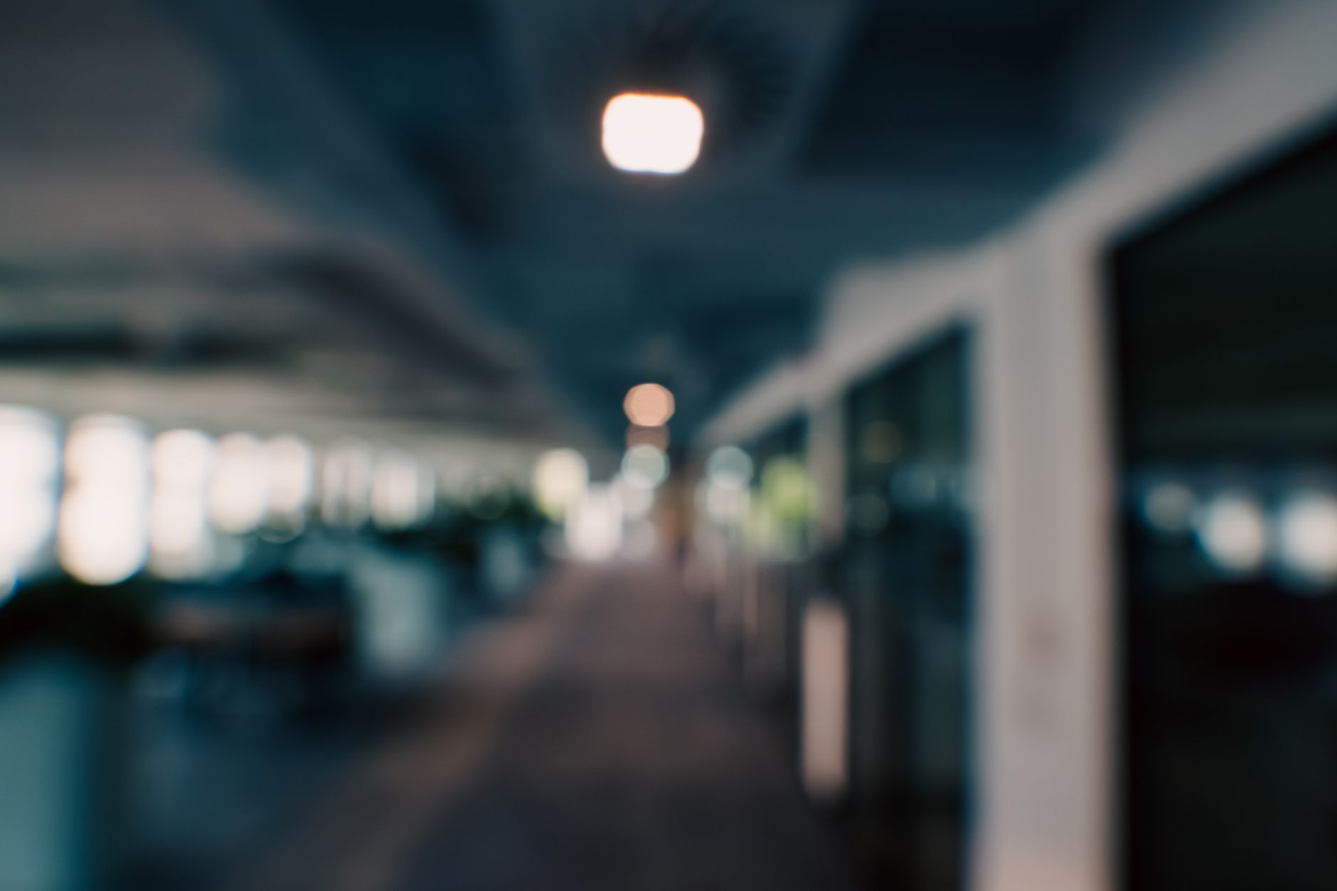 Abstract view of a modern office corridor with blurred ambient lighting, perfect for business or tech backgrounds.