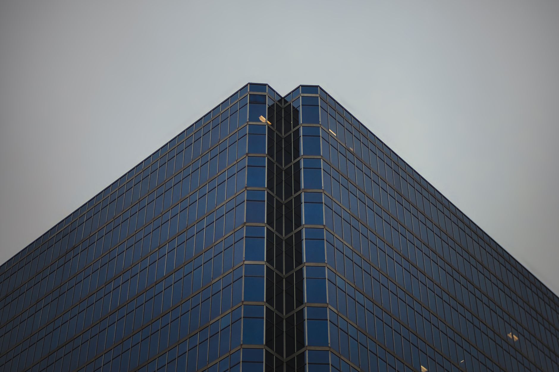 A striking view of a modern glass skyscraper in Vancouver, showcasing its architectural details.