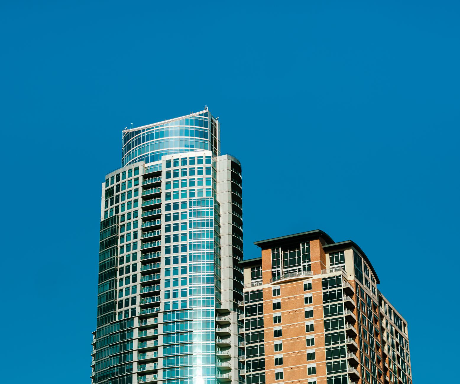 Stunning view of a modern skyscraper against a clear blue sky in Austin, Texas.